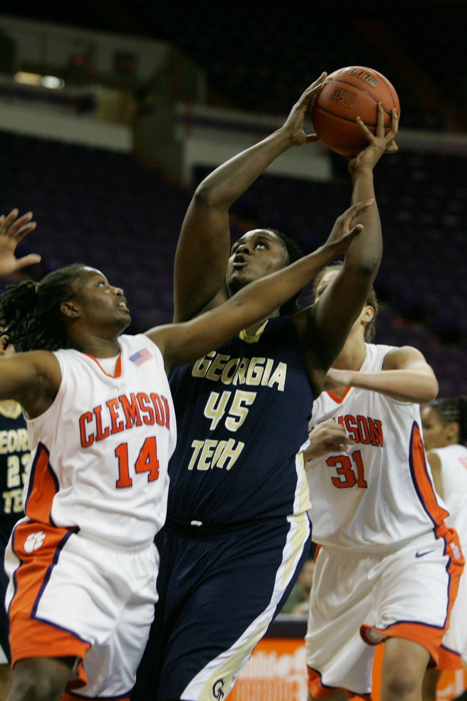 Georgia Tech's Sasha Goodlett (45) drives for the basket as Clemson's Keyrra Gillespie (14) gets called for the foul as she tries to block during the first half of an NCAA college basketball game Monday, Feb. 8, 2010, at Littlejohn Coliseum in Clemson, S.C. In the background is Clemson's Lindsey Mason (31). (AP Photo/Mary Ann Chastain)