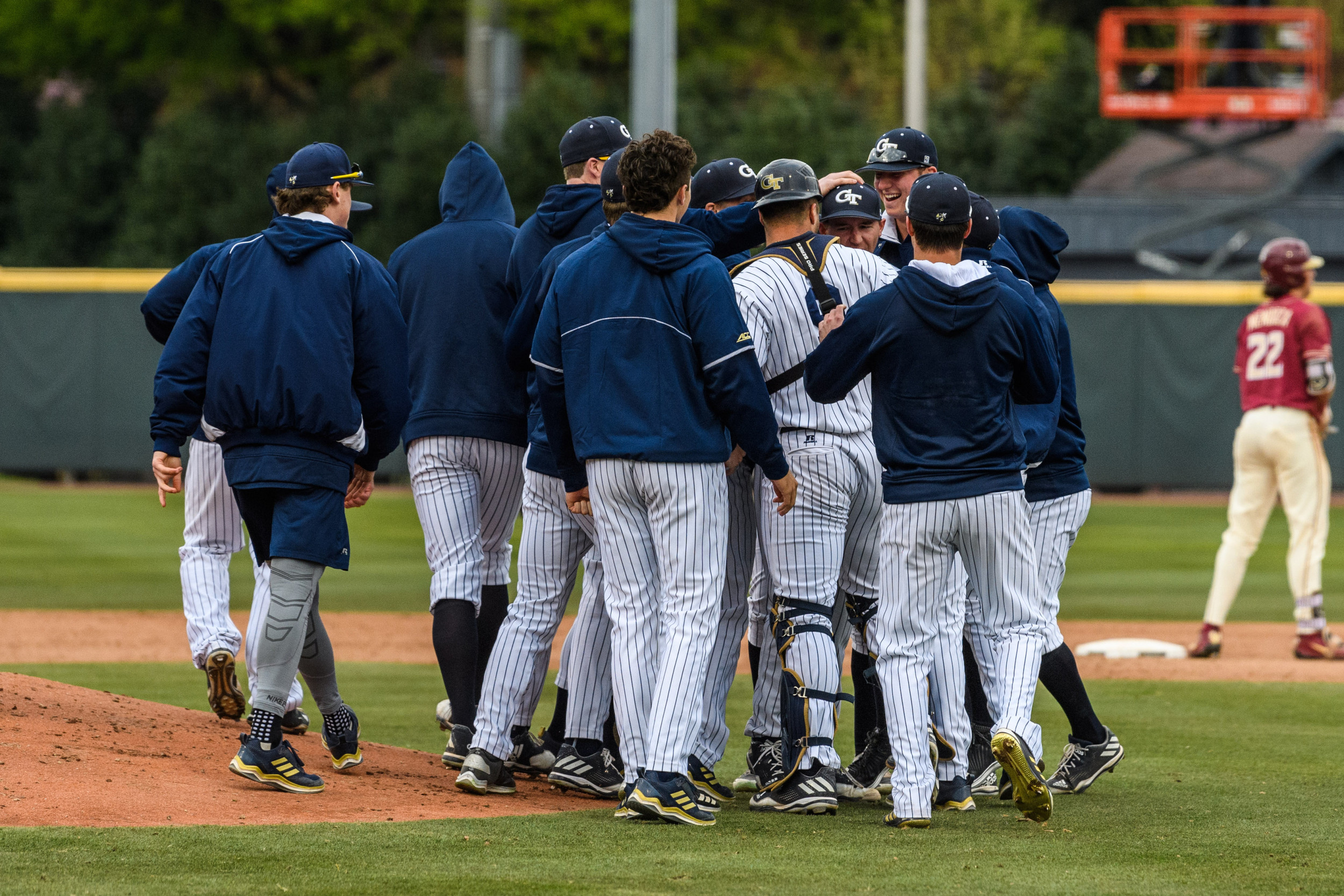 The team swarms Connor Thomas (42) after his complete game