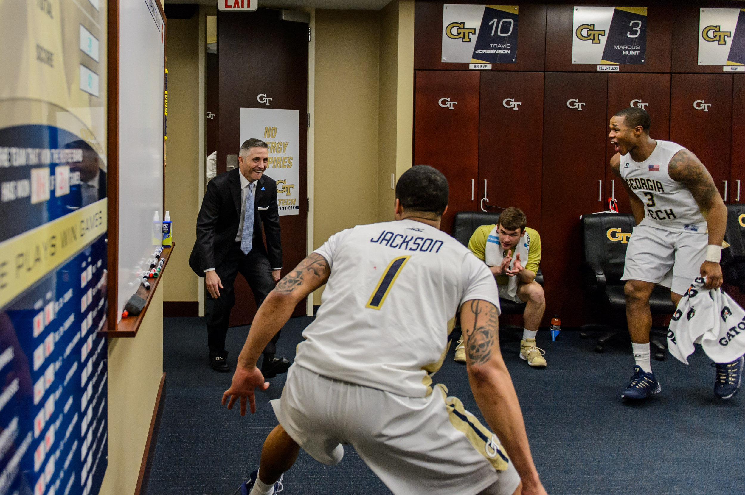 The team celebrates with Coach Gregory after the win