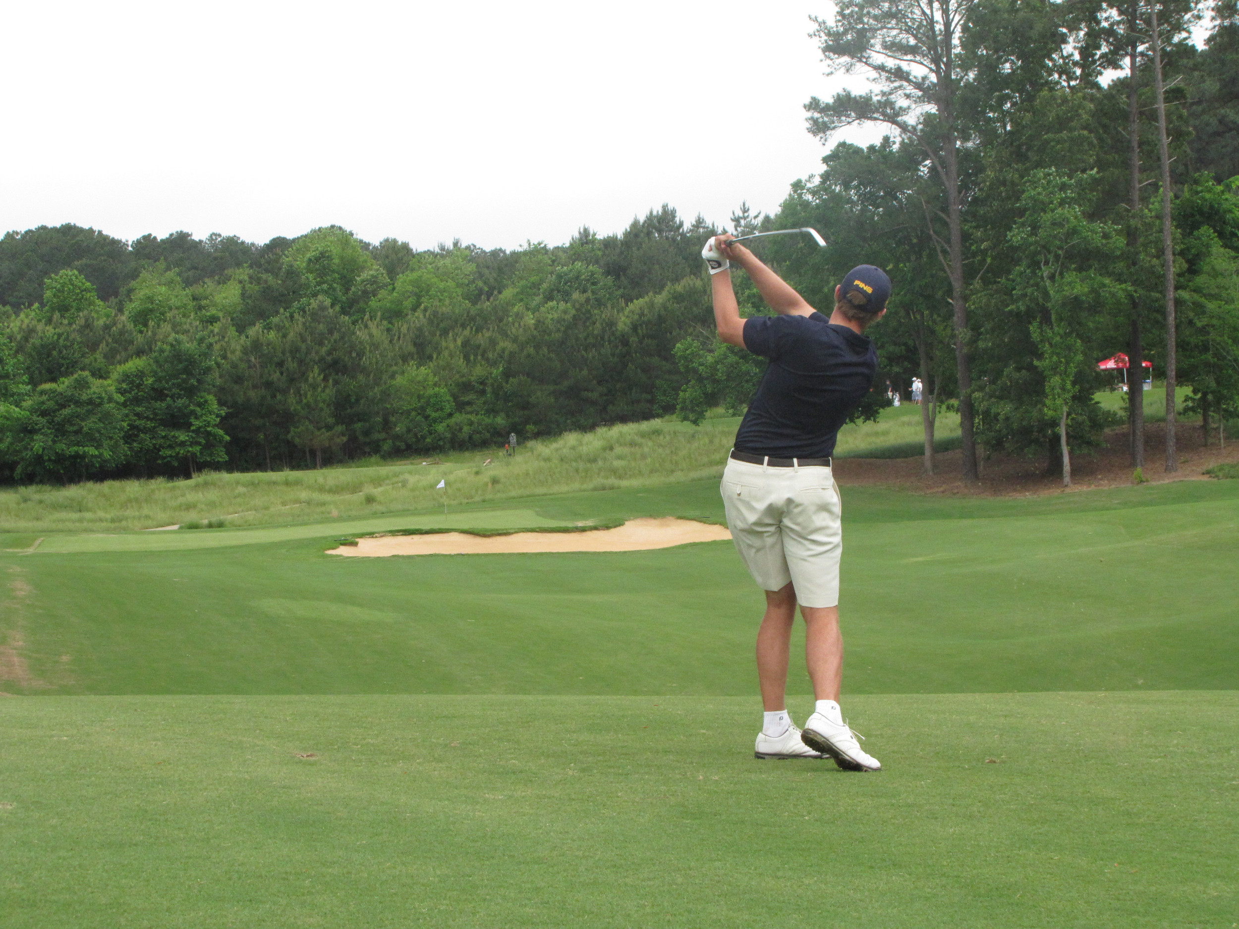 Bo Andrews hits his approach at No. 5 during the first round of the NCAA Raleigh Regional, May 15, 2014