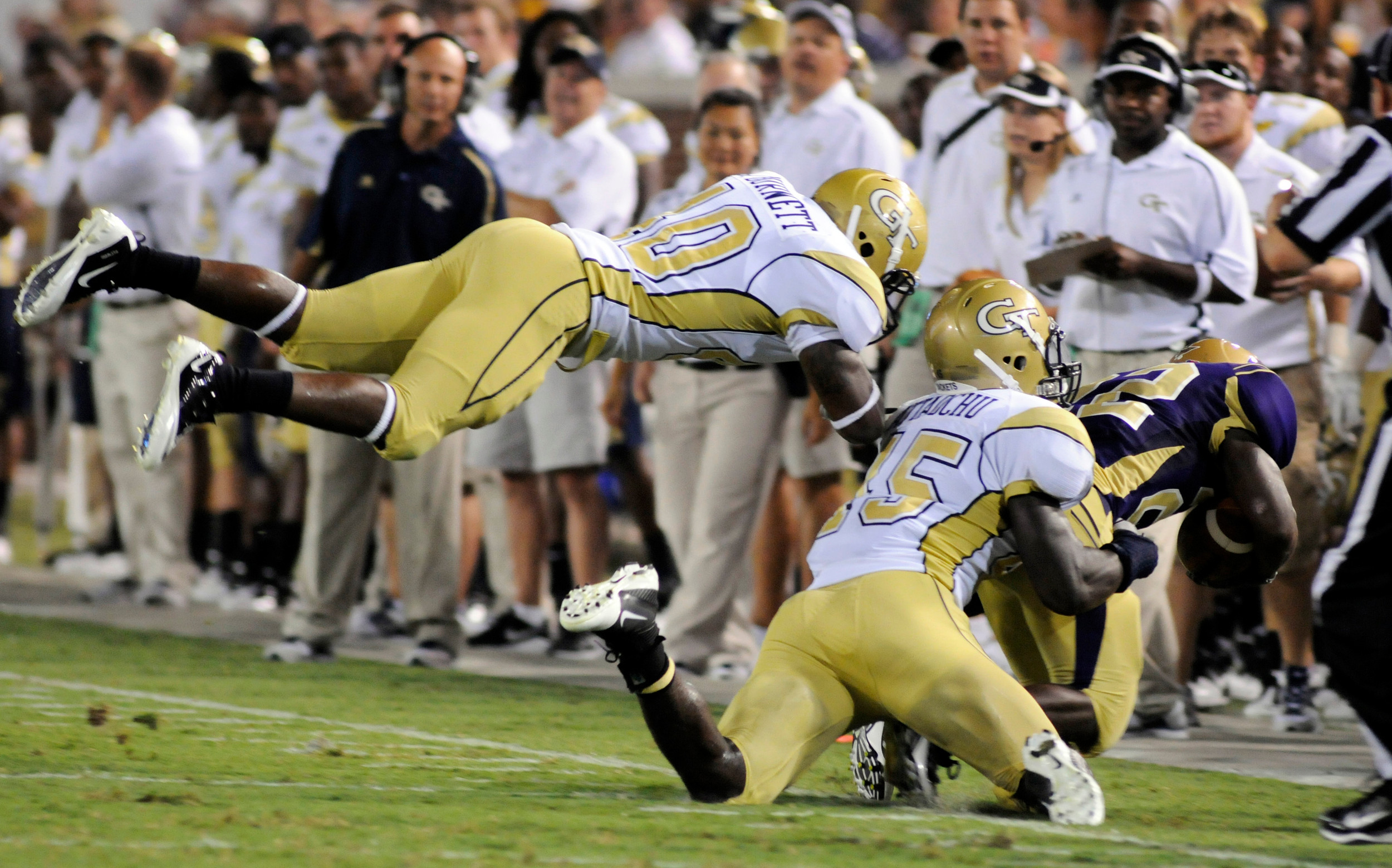 Georgia Tech's John Barnett, left, and Jeremiah Attaochu (45) tackle Western Carolina's Shaun Warren during an NCAA college football in Atlanta, Thursday, Sept. 1, 2011. AP Photo/Billy Weeks)