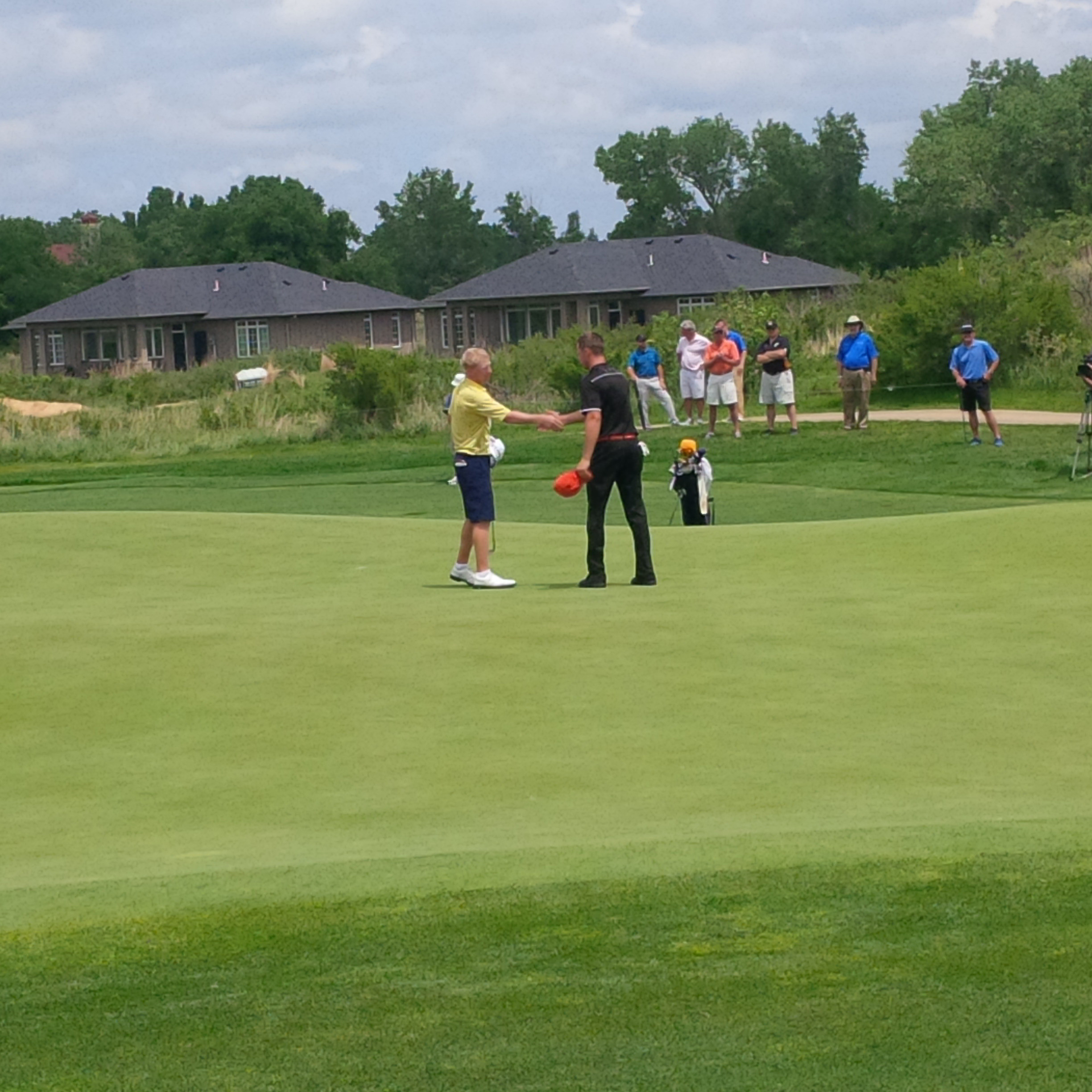Anders Albertson shakes hands with Wyndham Clark at the end of their NCAA quarterfinal match, May 26, 2014