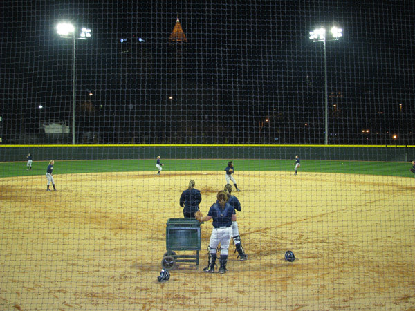 Softball team practices at night for the first time in its new stadium.