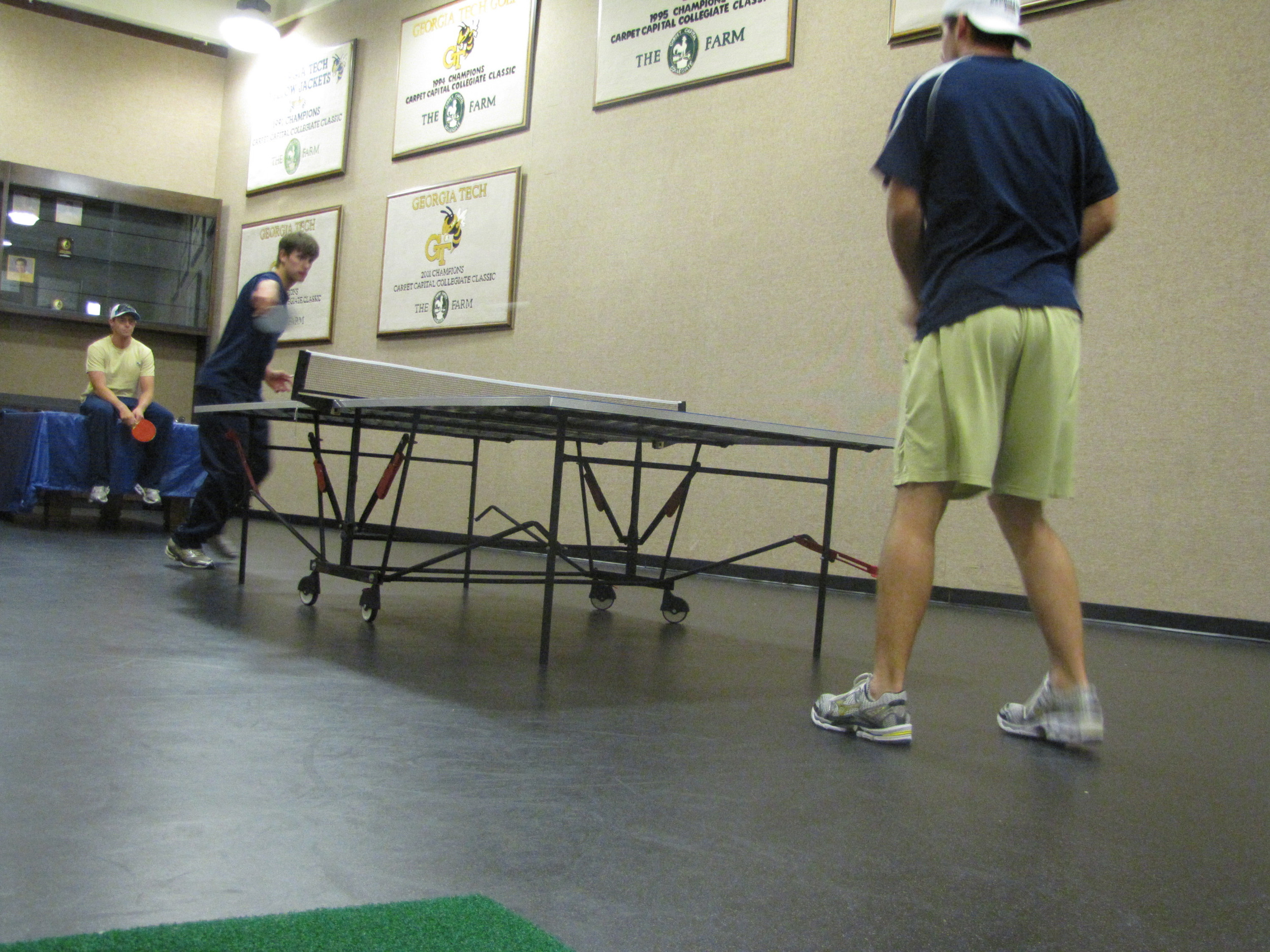 Tech golfers playing ping-pong in the team's workout room.