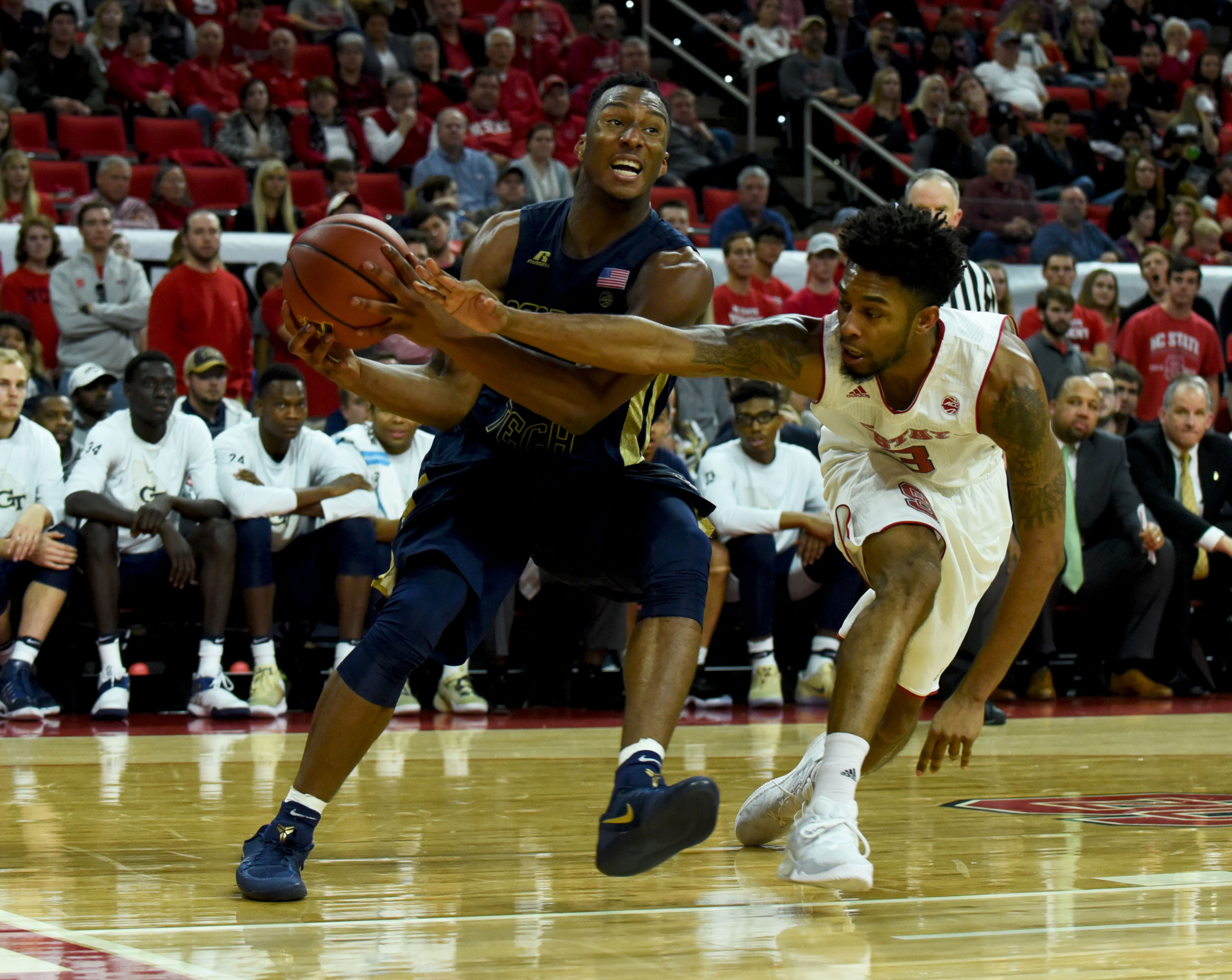 Guard Josh Okogie drives to the basket as North Carolina State Wolfpack guard Terry Henderson defends during the second half. The Yellow Jackets won 86-76. Credit: Rob Kinnan-USA TODAY Sports