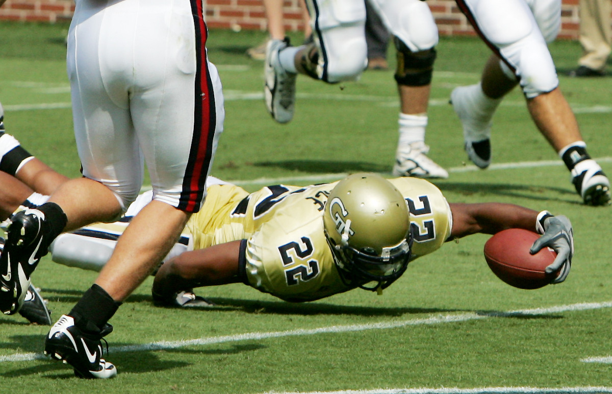 Tashard Choice reaches past Samford safety B.T. Hartloge for a first half touchdown. (AP Photo/Ric Feld)