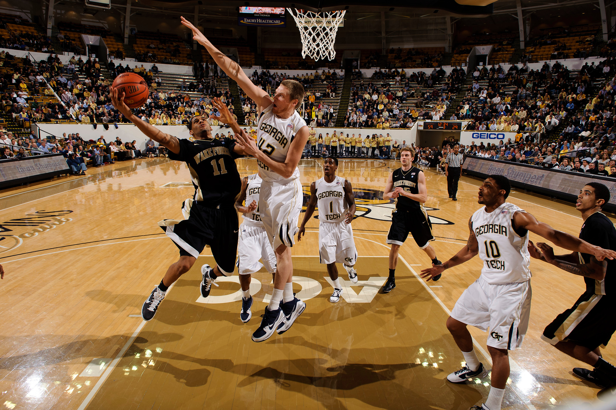 Jan 19, 2011; Atlanta, GA, USA; Georgia Tech Yellow Jackets center Nate Hicks (42) defends as Wake Forest Demon Deacons guard C.J. Harris (11) shoots during the second half at Alexander Memorial Coliseum. Georgia Tech defeated Wake Forest 74-39. Mandatory Credit: Paul Abell-US PRESSWIRE