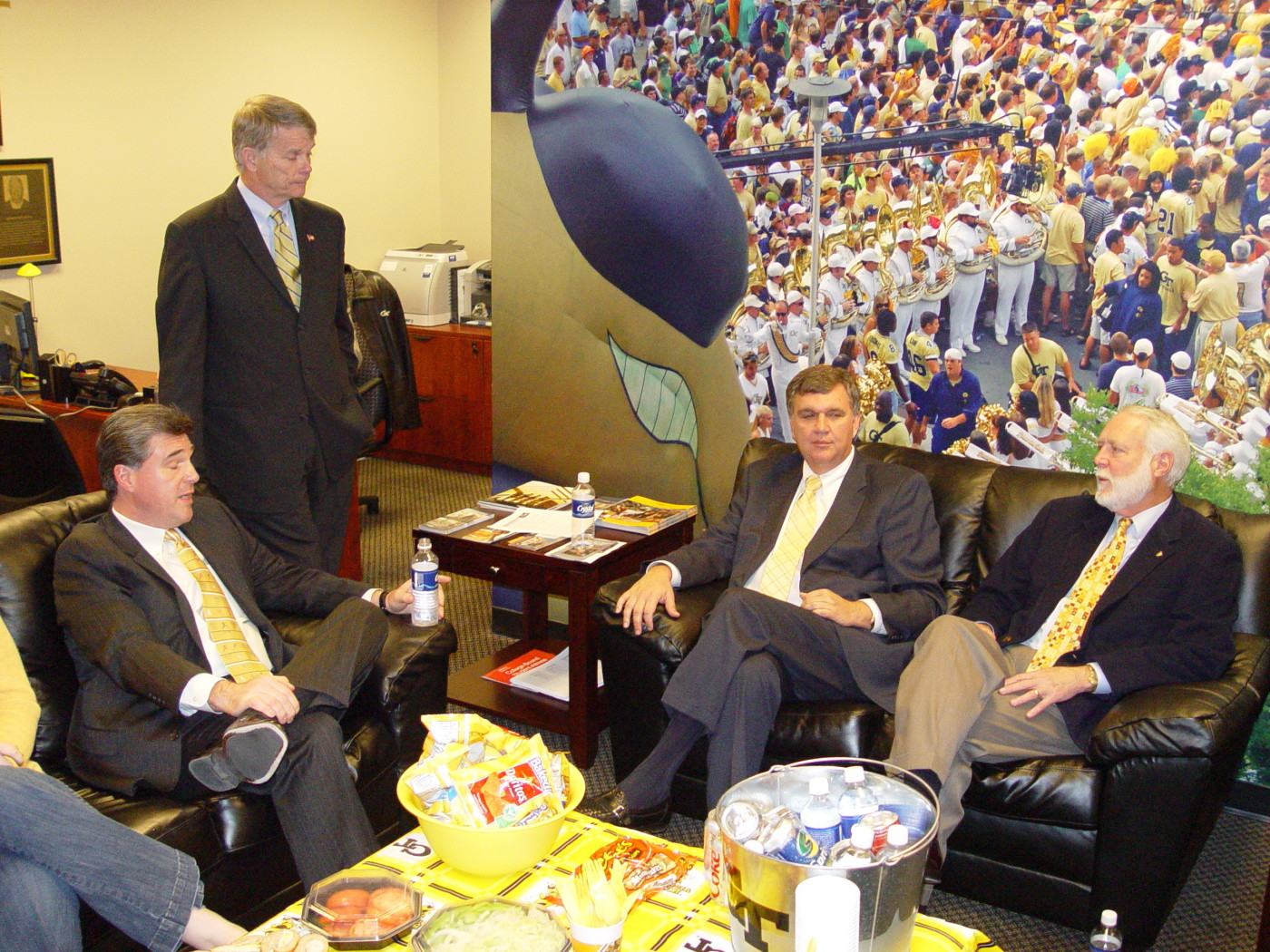 Paul Johnson visits with Dan Radakovich (seated left) and Georgia Tech president Wayne Clough.