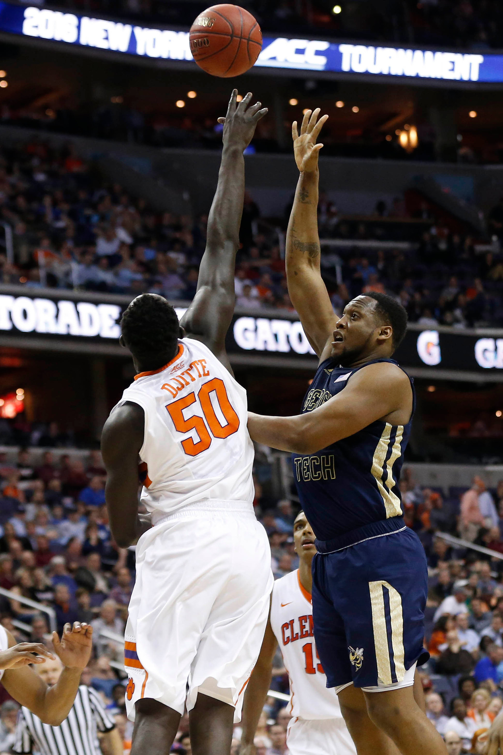 Mar 9, 2016; Washington, DC, USA; Georgia Tech Yellow Jackets forward Charles Mitchell (0) shoots the ball over Clemson Tigers center Sidy Djitte (50) in the second half during day two of the ACC conference tournament at Verizon Center. The Yellow Jackets won 88-85 in overtime. Mandatory Credit: Geoff Burke-USA TODAY Sports