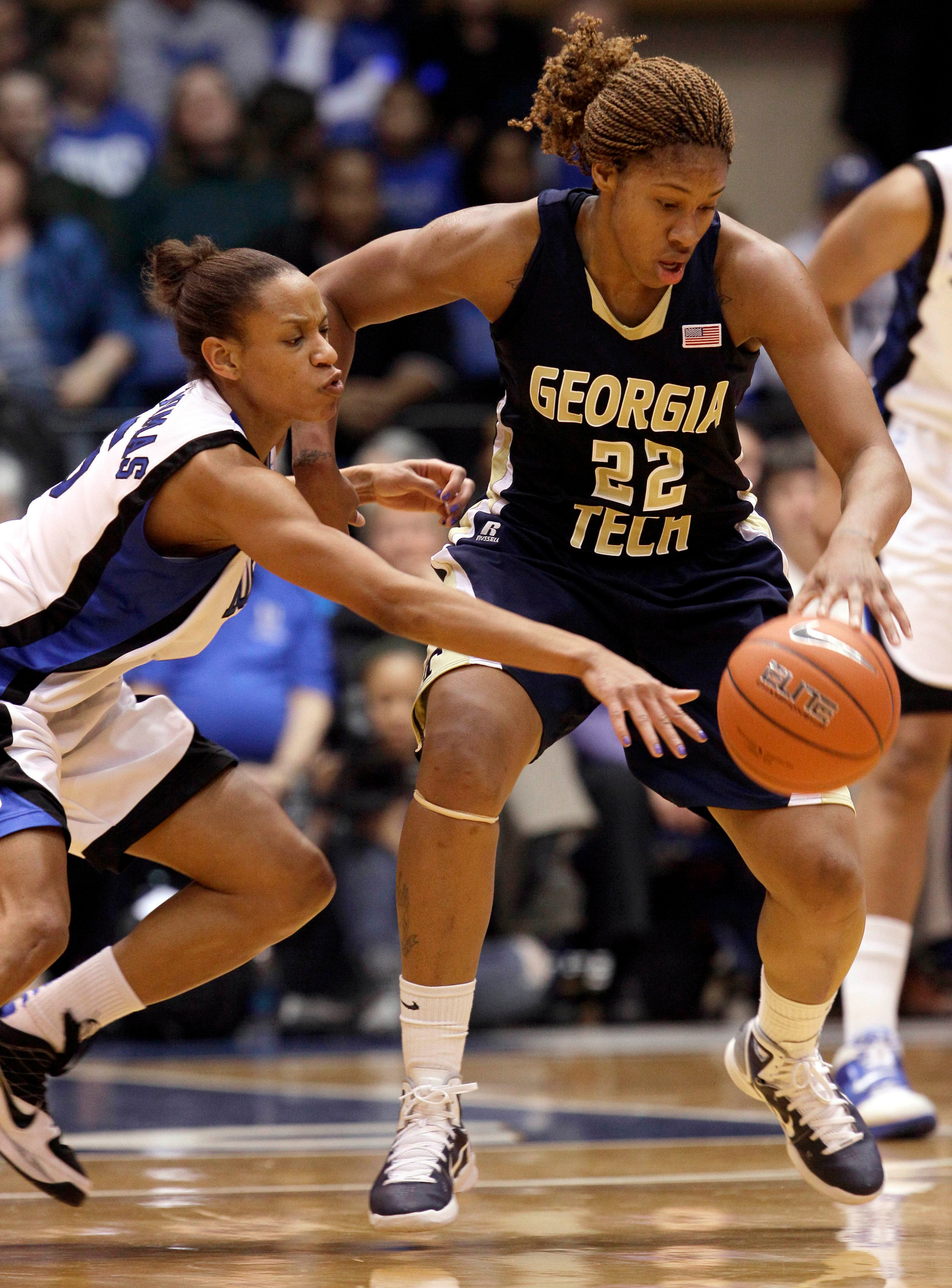 Duke's Jasmine Thomas, left, reaches for the ball as Georgia Tech's Alex Montgomery (22) dribbles during the first half of an NCAA college basketball game in Durham, N.C., Friday, Jan. 21, 2011. (AP Photo/Gerry Broome)