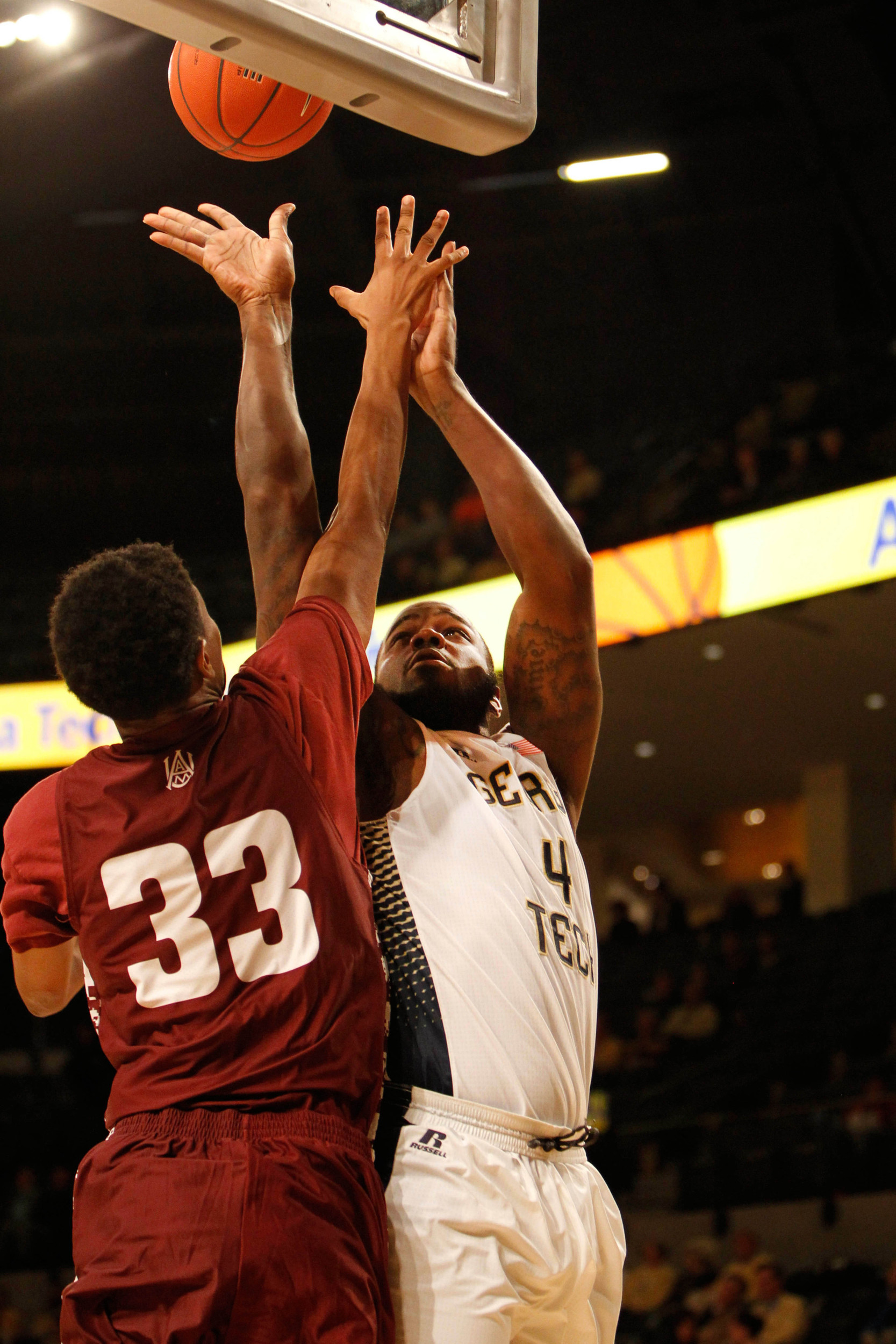 Nov 18, 2014; Atlanta, GA, USA; Yellow Jackets center Demarco Cox (4) shoots the ball over Alabama A&M Bulldogs guard Baryn Houston (33) in the first half. Brett Davis-USA TODAY Sports