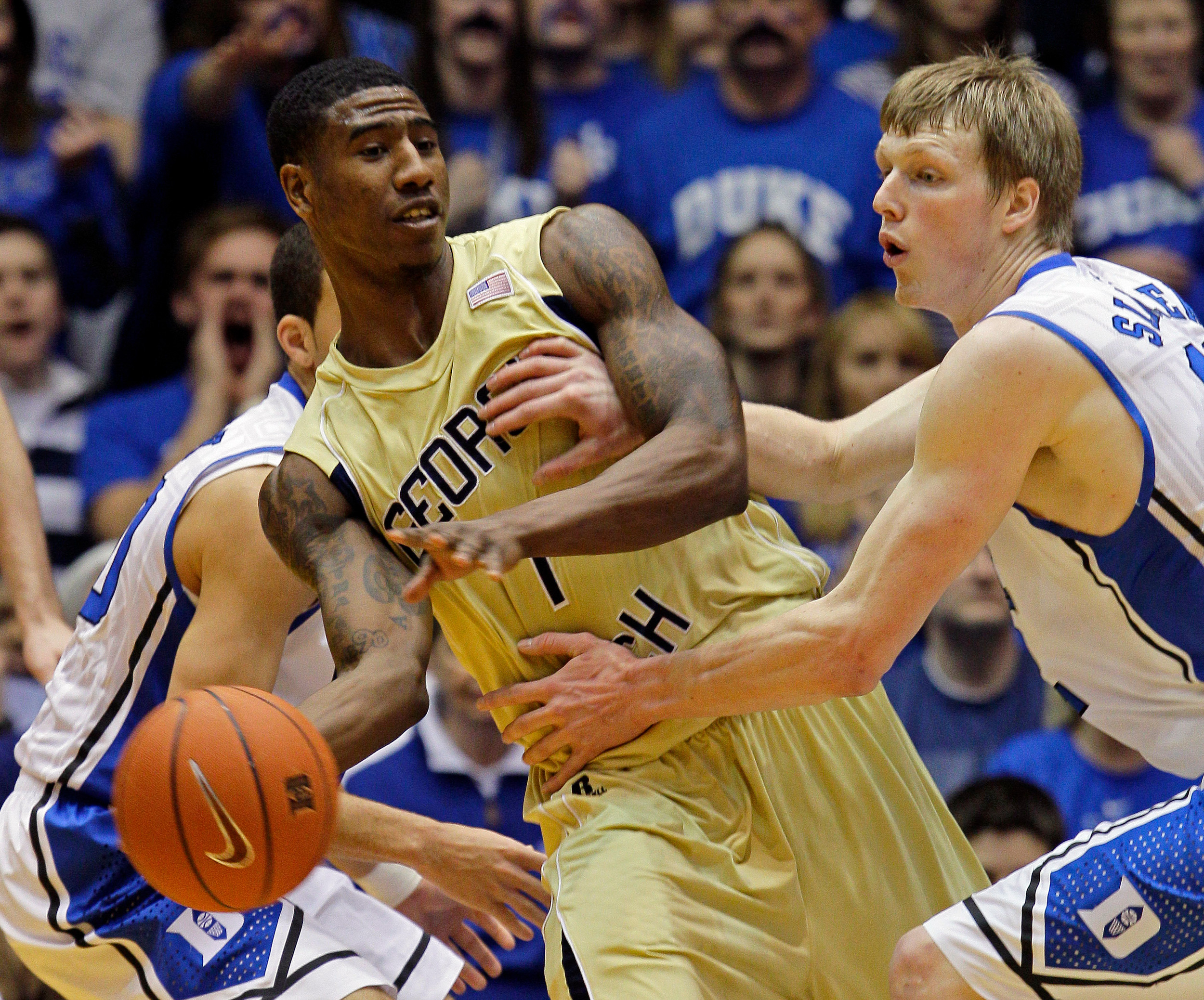Duke's Kyle Singler, right, pressures Georgia Tech's Iman Shumpert, center, during the first half. (AP Photo/Gerry Broome)