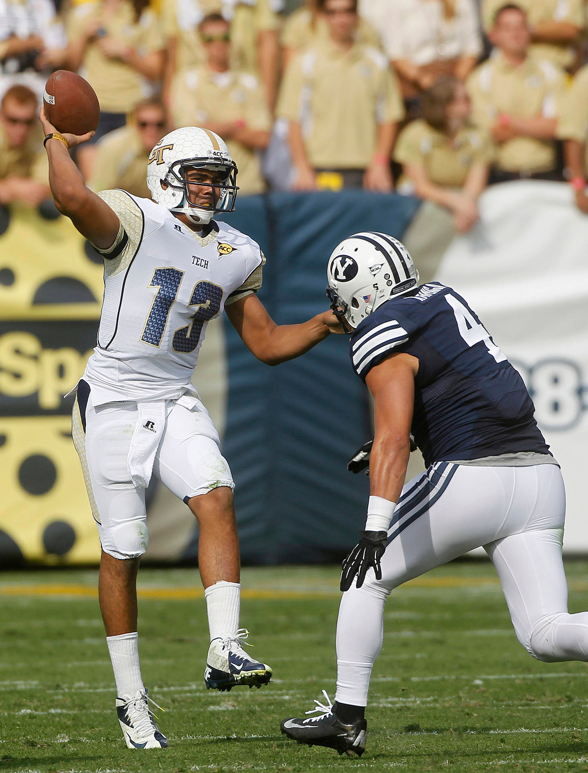 Georgia Tech quarterback Tevin Washington (13) throws under pressure from Bringham Young linebacker Uona Kaveinga (4) in the first half. (AP Photo/John Bazemore)