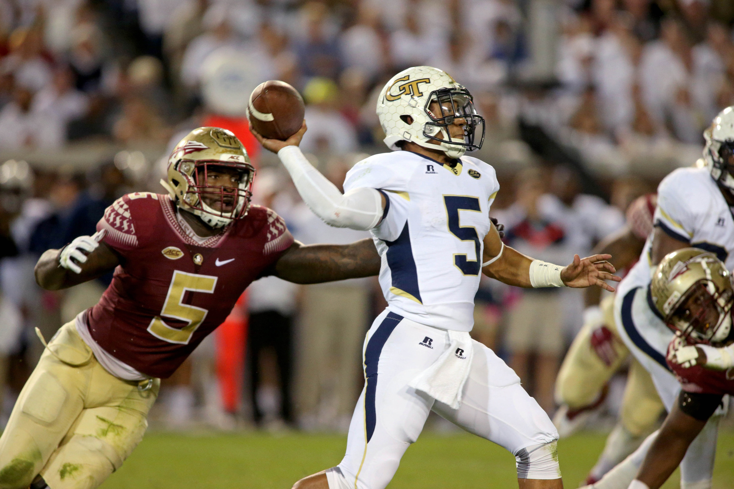 Georgia Tech Yellow Jackets quarterback Justin Thomas (5) attempts a pass against Florida State Seminoles linebacker Reggie Northrup (5) in the second quarter of their game at Bobby Dodd Stadium. Credit: Jason Getz-USA TODAY Sports