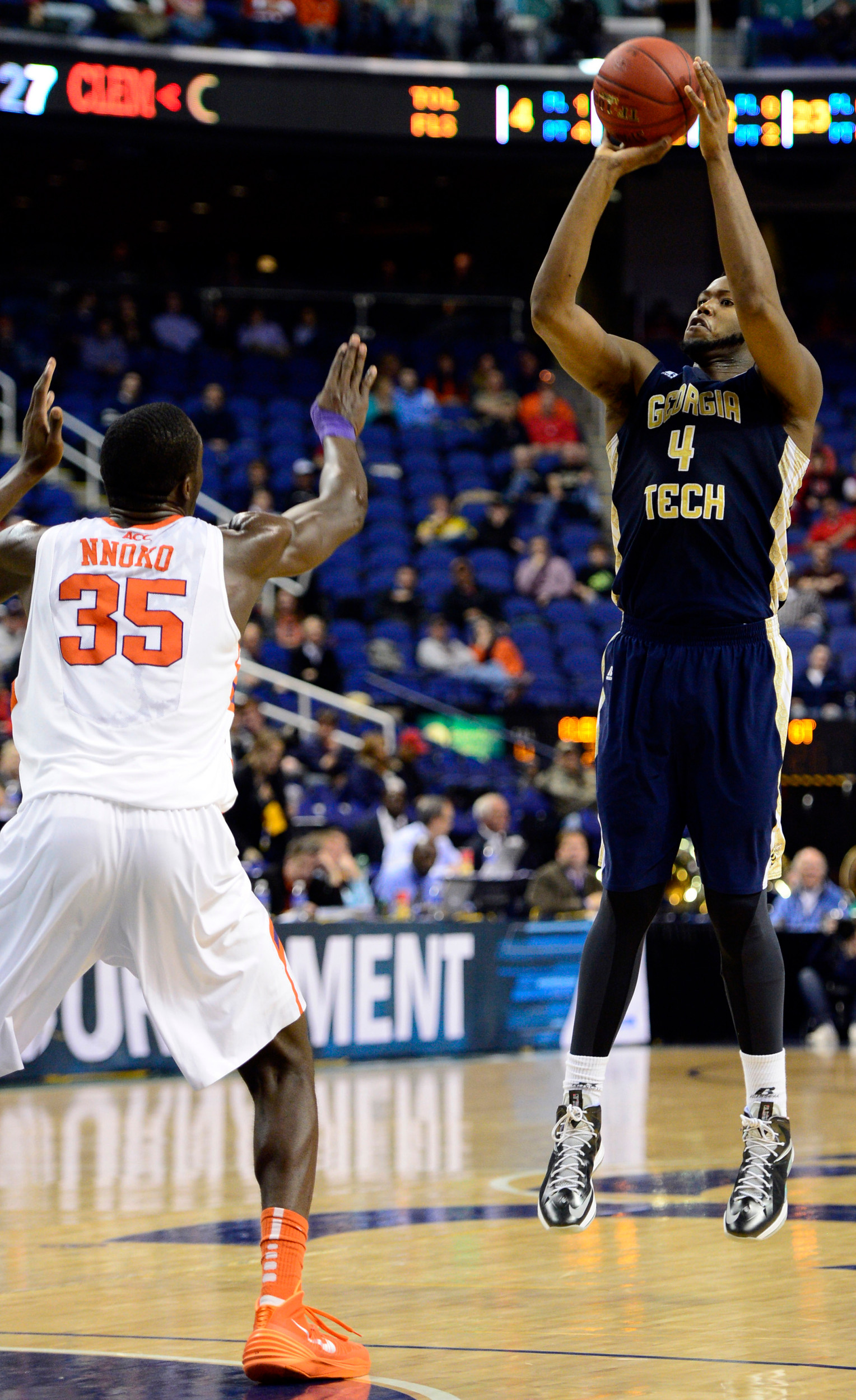 Mar 13, 2014; Greensboro, NC, USA; Georgia Tech Yellow Jackets forward Robert Carter, Jr. (4) goes up for a jump shot over Clemson Tigers center Landry Nnoko (35) in the second round of the ACC college basketball tournament at Greensboro Coliseum. Mandatory Credit: John David Mercer-USA TODAY Sports