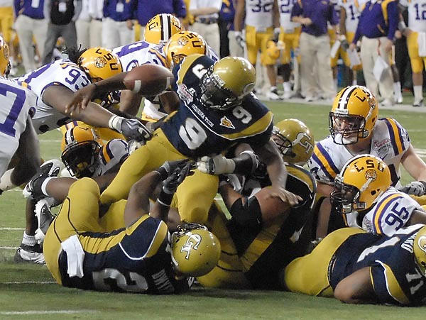 Josh Nesbitt (9) watches as the ball comes out of his grasp late in the game. The ball was recovered by LSU. Photo by LensEffects