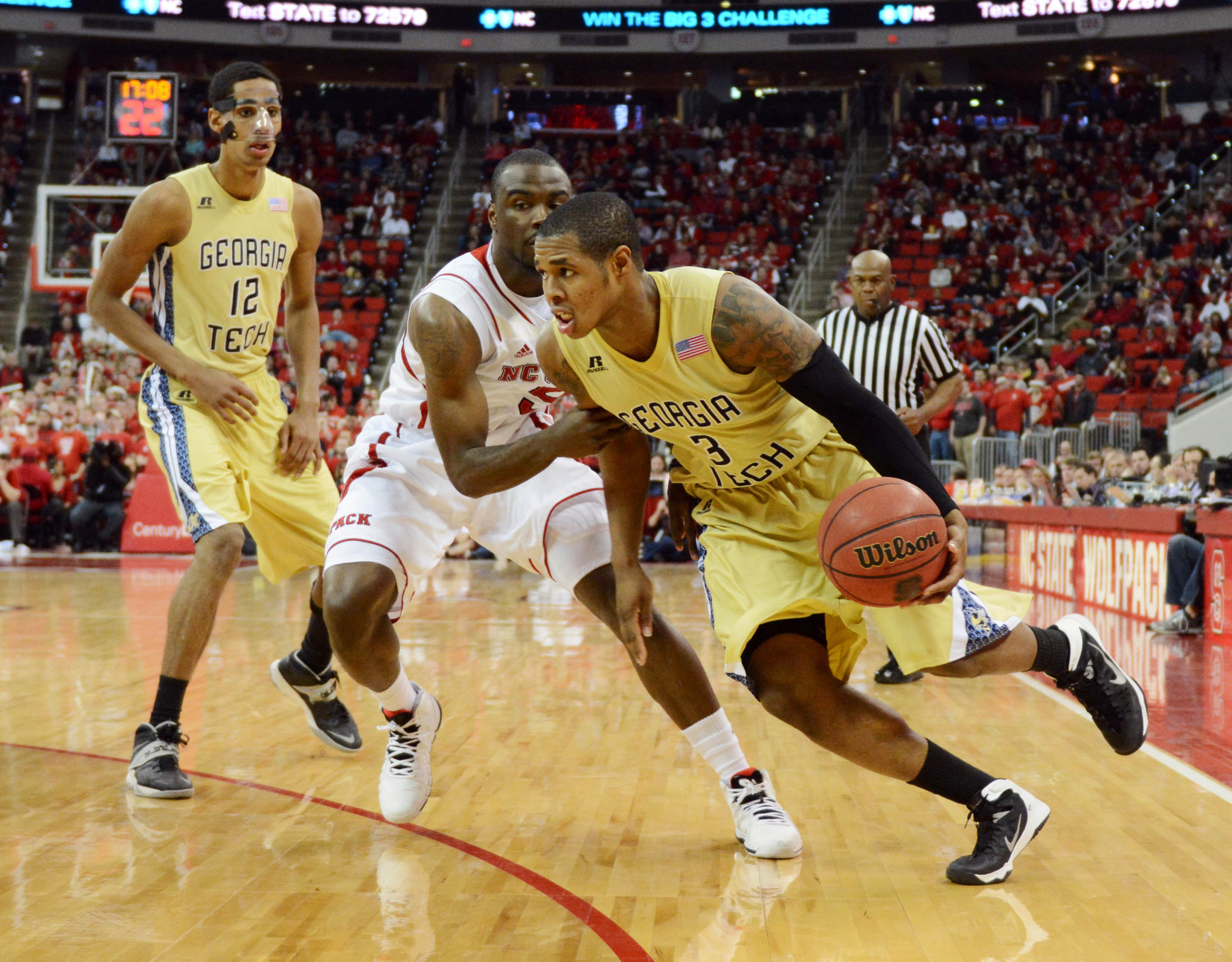 Jan 26, 2014; Raleigh, NC, USA; Georgia Tech Yellow Jackets guard Marcus Georges-Hunt (3) dribbles around North Carolina State Wolfpack guard Desmond Lee (5) during the second half at PNC Arena. North Carolina State won 80-78 in overtime. Mandatory Credit: Rob Kinnan-USA TODAY Sports