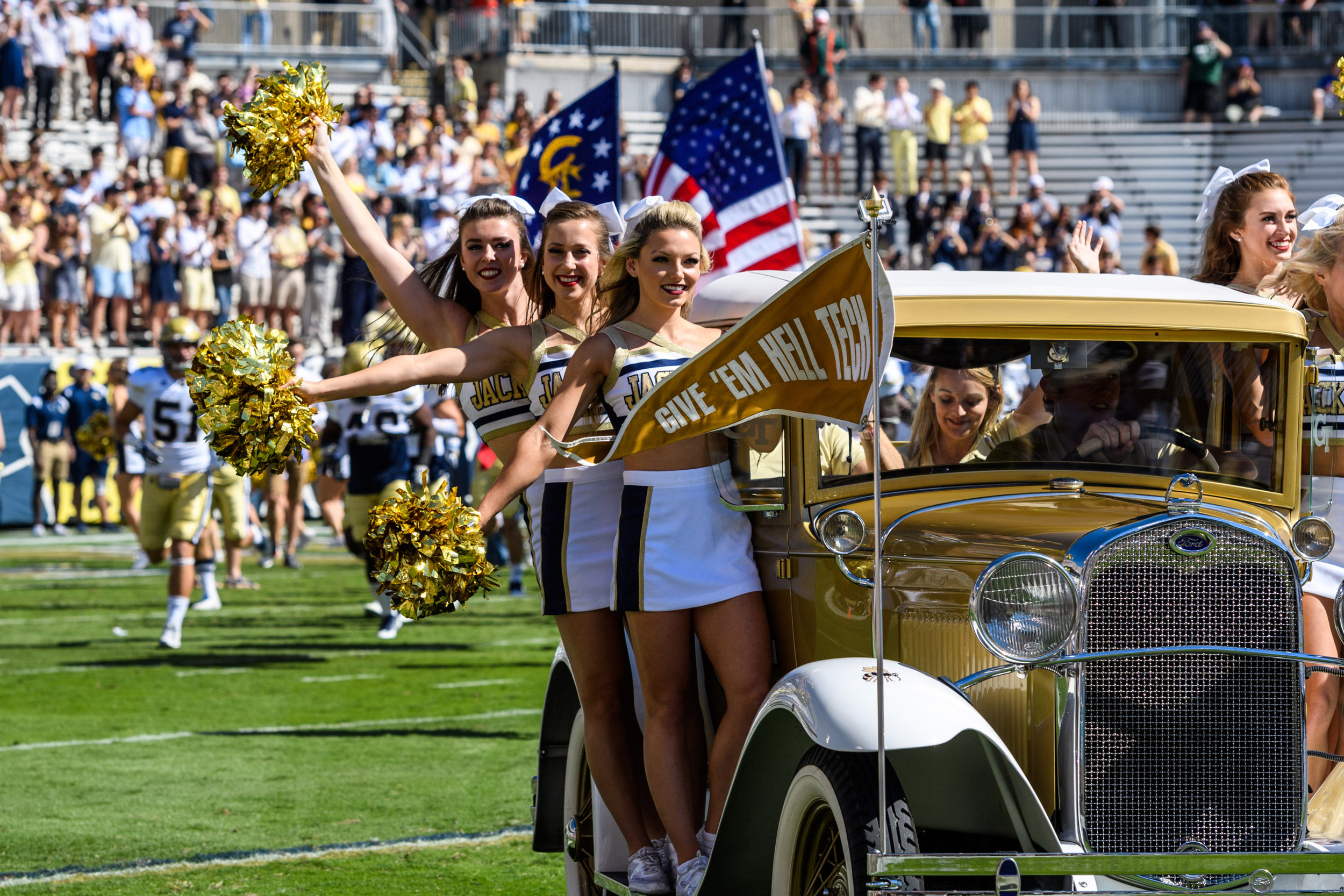 The cheerleaders ride the Reck onto the field