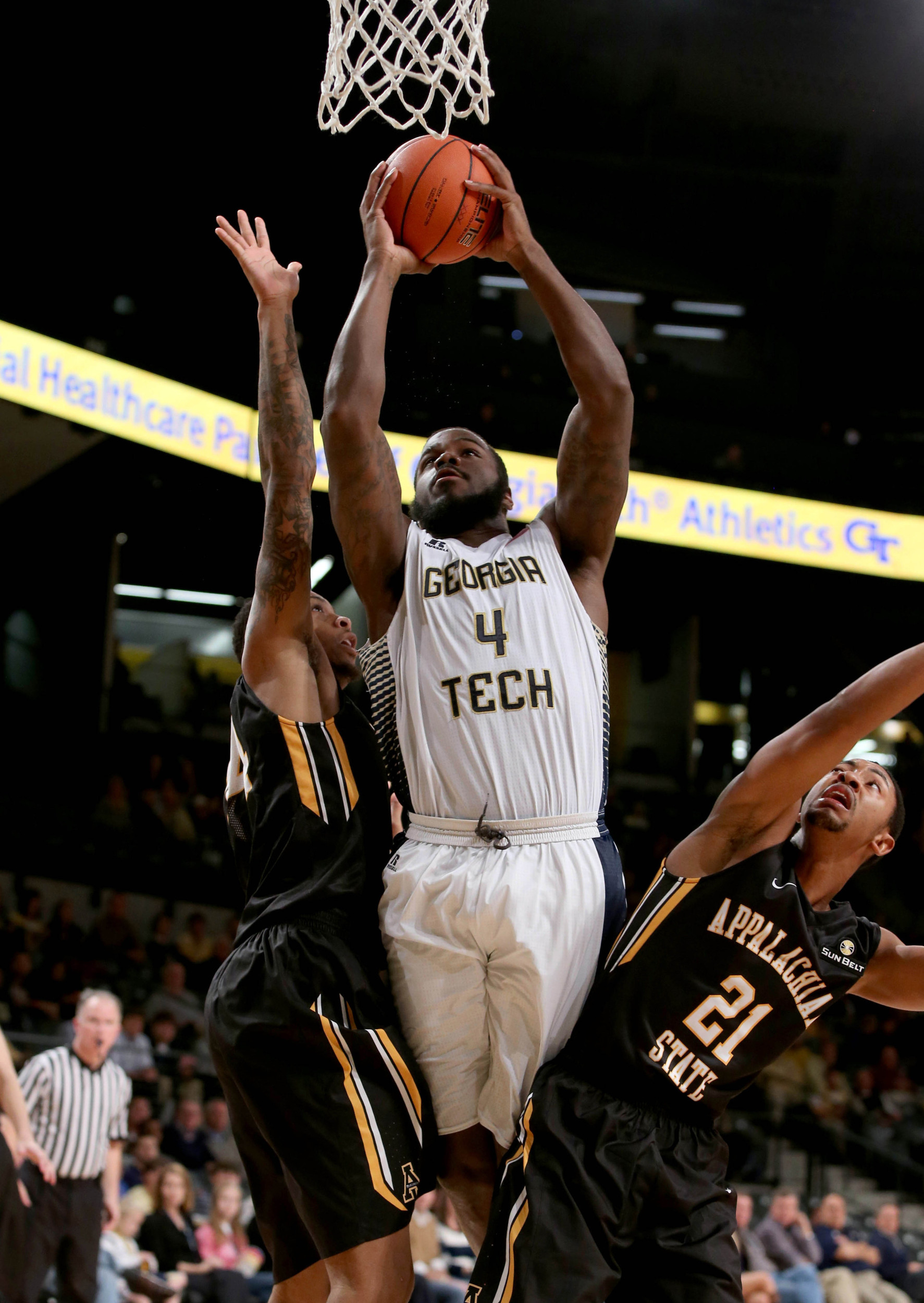 Dec 15, 2014; Atlanta, GA, USA; Georgia Tech Yellow Jackets center Demarco Cox (4) attempts a basket as he is fouled by Appalachian State Mountaineers forward Jacob Lawson (34) in the second half of their game at McCamish Pavilion. Also shown on the play is Appalachian State Mountaineers guard Frank Eaves (21). Georgia Tech won 70-57. Mandatory Credit: Jason Getz-USA TODAY Sports