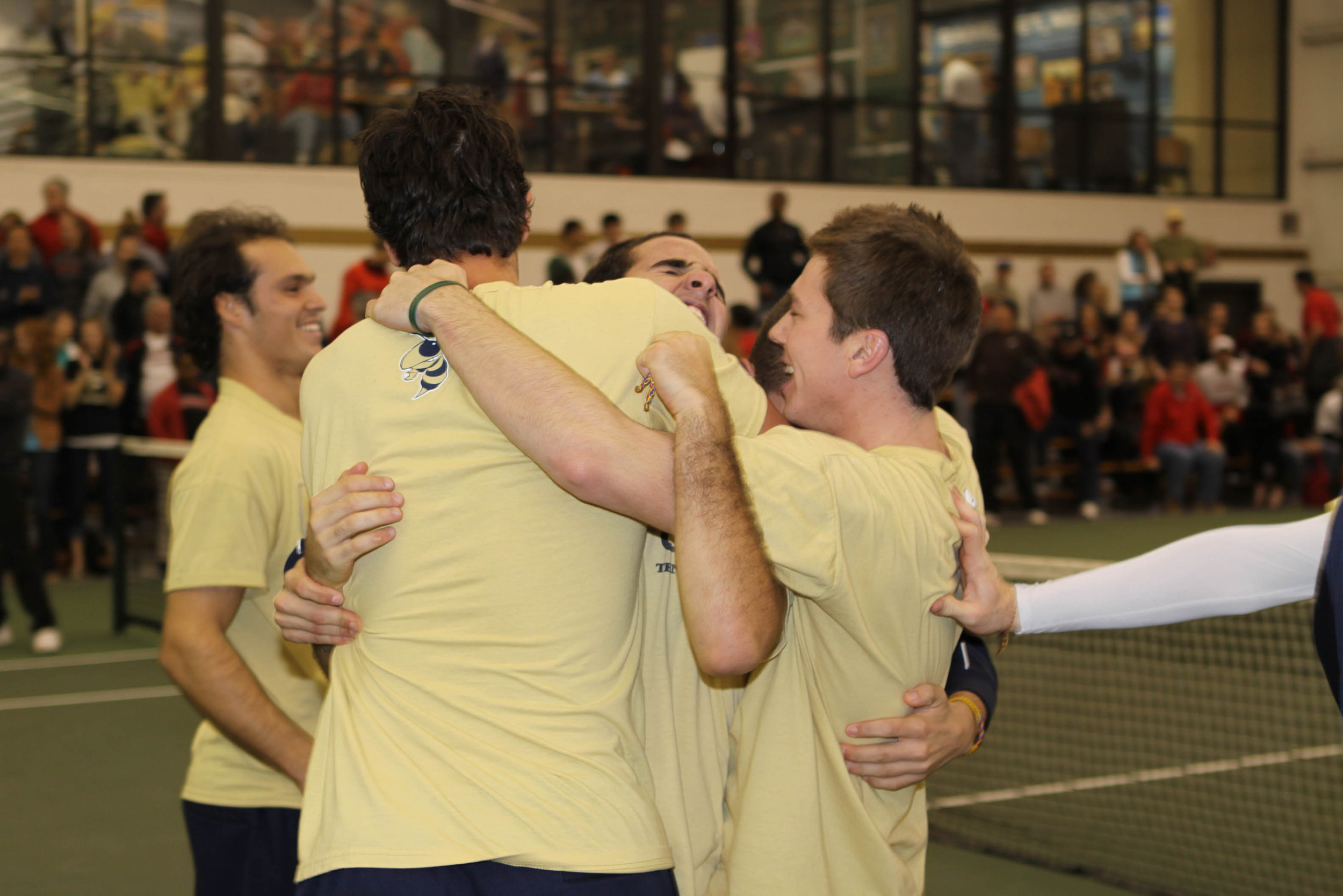 The men's tennis team celebrates