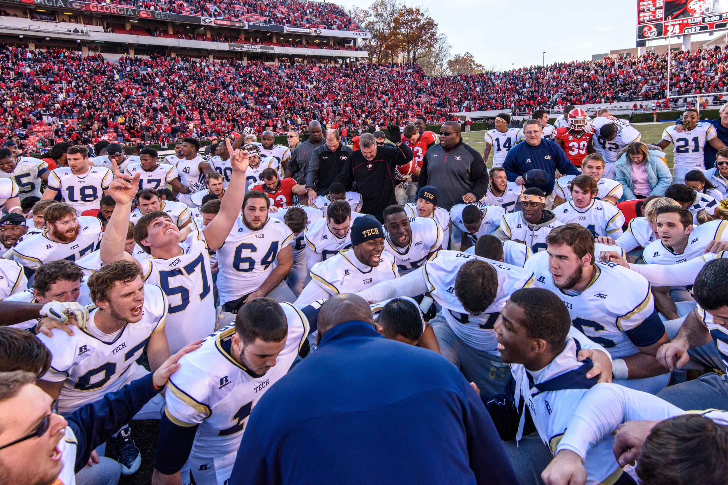 Team Chaplain Derrick Moore prays with the team after the win