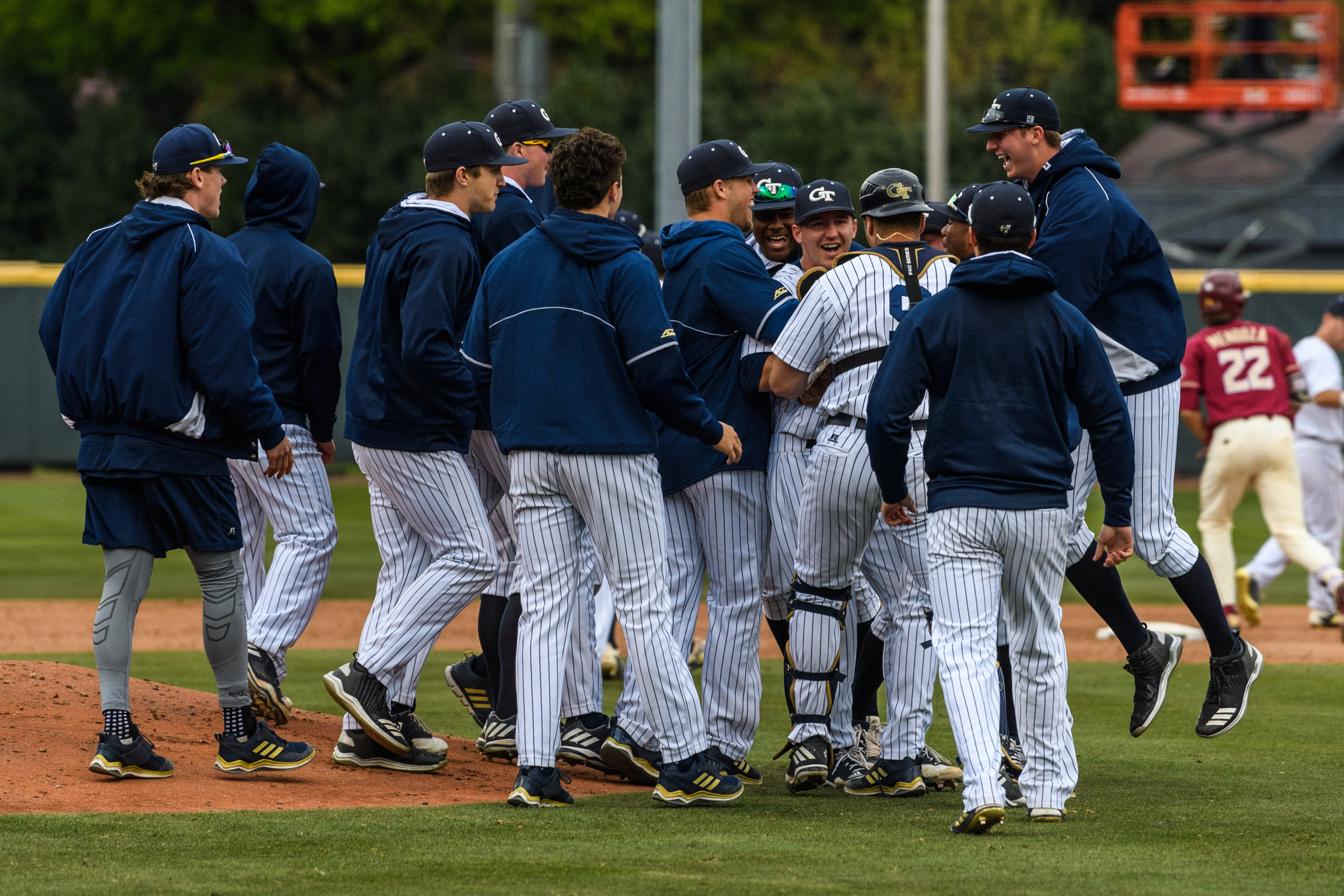 The team swarms Connor Thomas (42) after his complete game