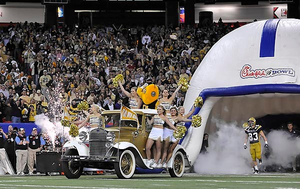 The Ramblin Wreck makes its entrance into the Georgia Dome prior to the start of the game. Photo by LensEffects