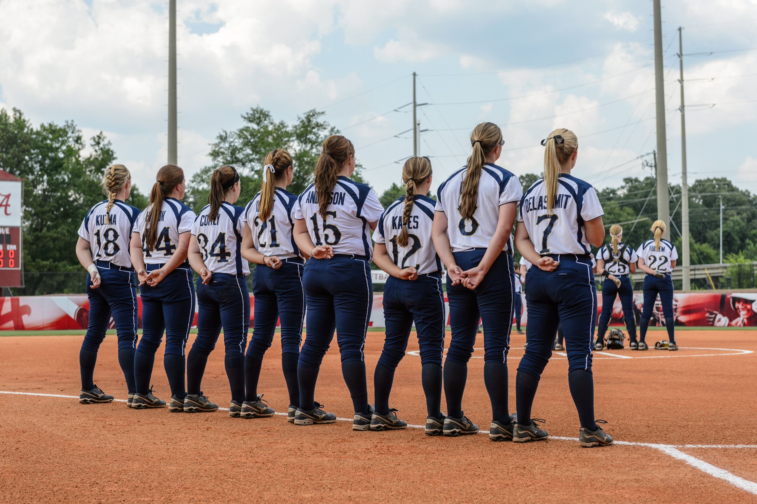 The non-starters line the bases during the National Anthem.