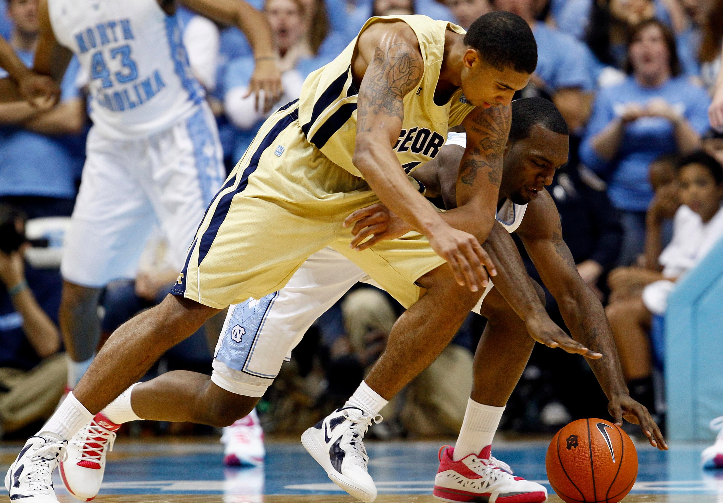 Georgia Tech's Glen Rice Jr., left, and North Carolina's P.J. Hairston scramble for a loose ball during the first half of an NCAA college basketball game in Chapel Hill, N.C., Sunday, Jan. 29, 2012. (AP Photo/Gerry Broome)