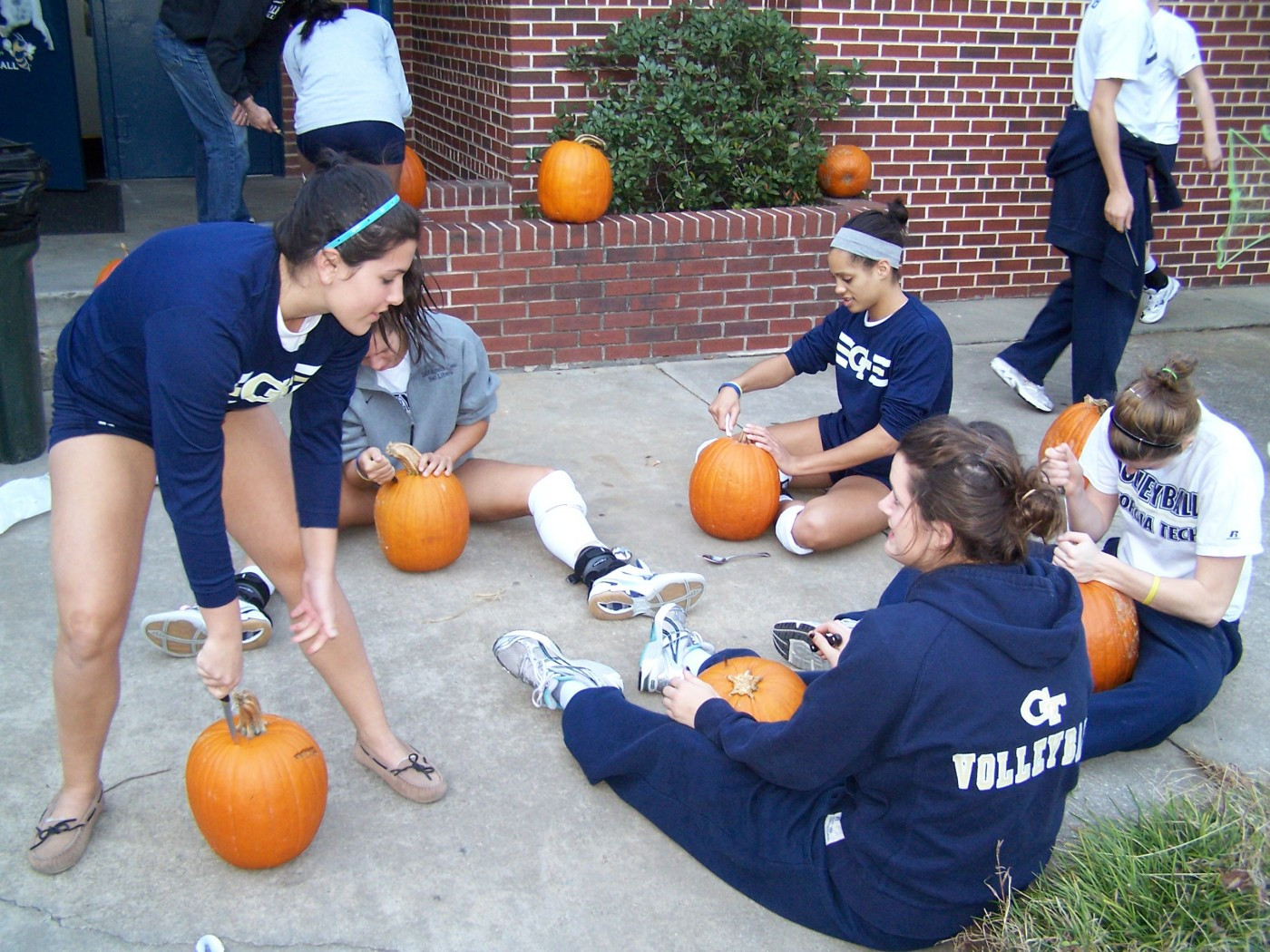 (From L-R) Michelle Kandell, Callie Miller, Talisa Kellogg and Alison Campbell begin carving pumpkins the day before Volleyball-o-ween.