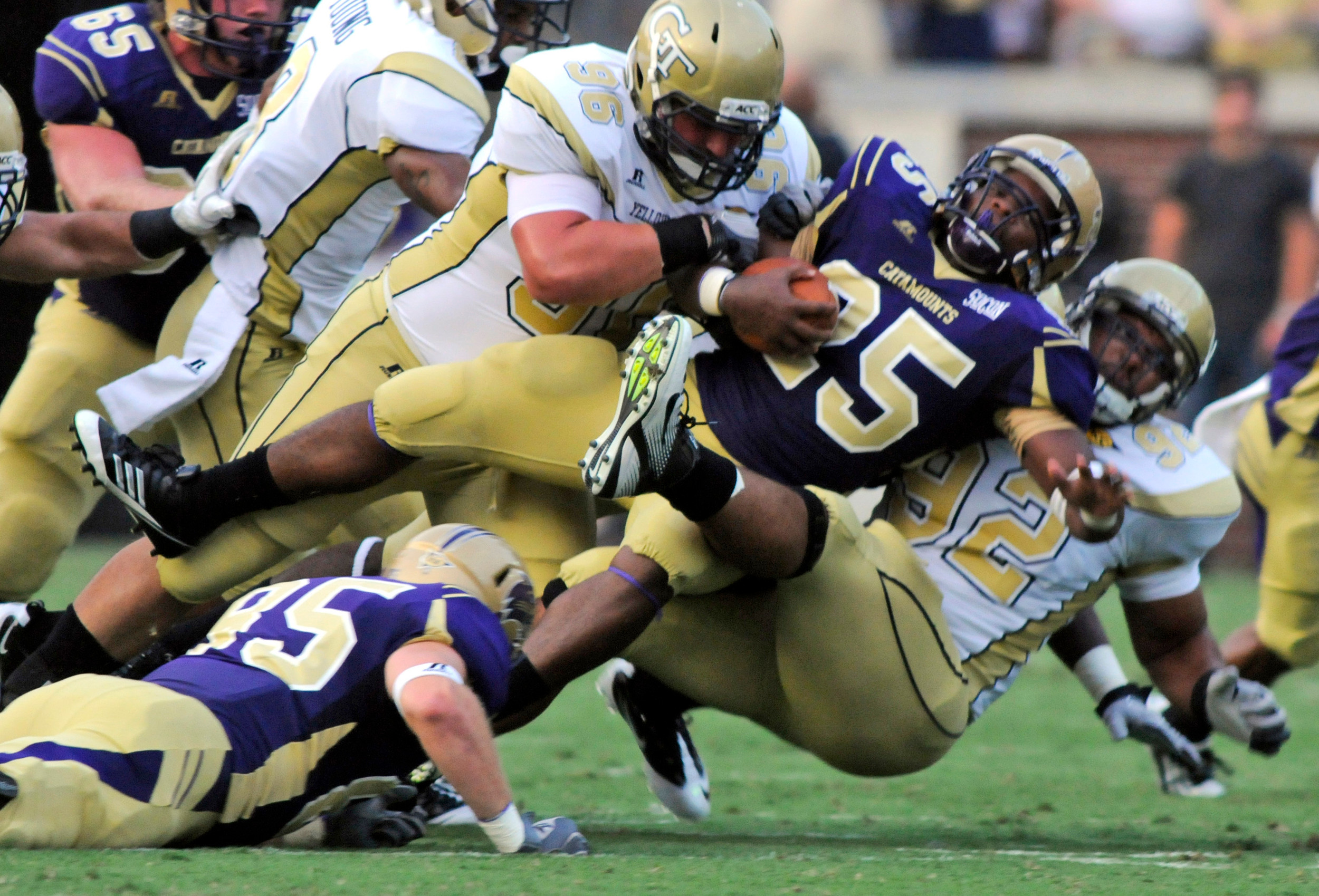 Western Carolina running back Michael Vaughn is tackled by Georgia Techs' Logan Walls (96) and Jason Peters (92) during an NCAA college football in Atlanta, Thursday, Sept. 1, 2011. AP Photo/Billy Weeks)