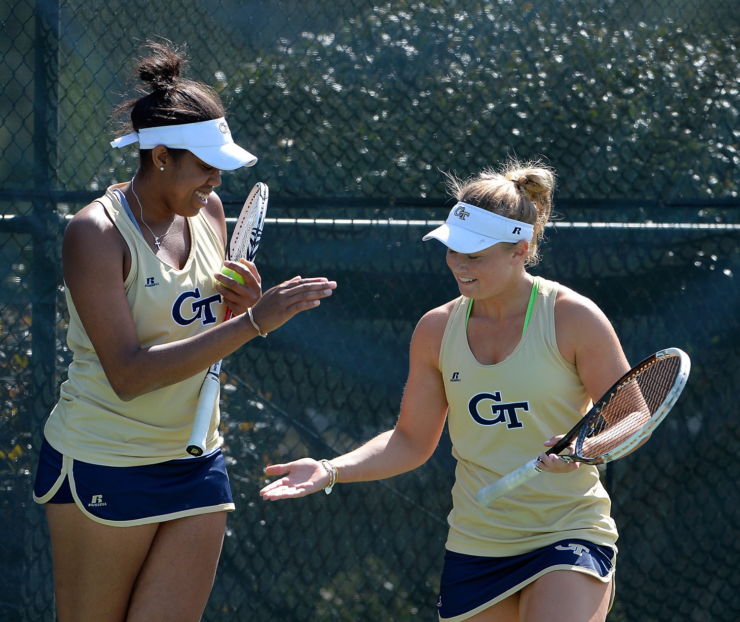 Georgia Tech's Kendal Woodard and Paige Hourigan slap hands during their doubles match against Duke during the 2015 ACC Women's Tennis Tournament in Cary, N.C., April. 24, 2015. (Photo by Sara D. Davis, theACC.com)