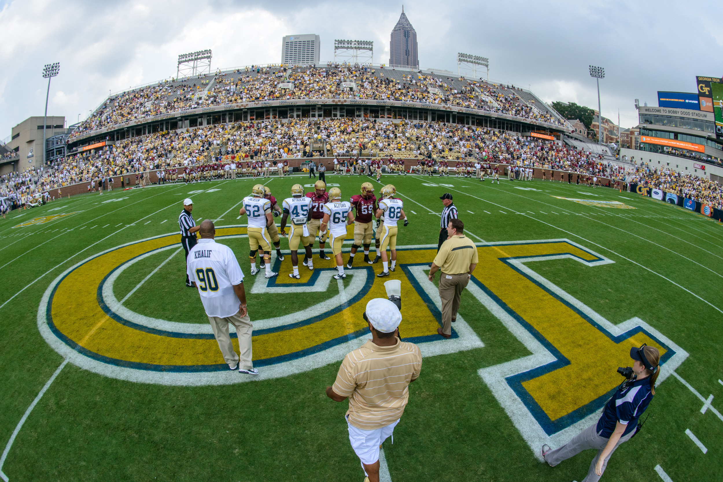 The teams meet at midfield for the coin toss.