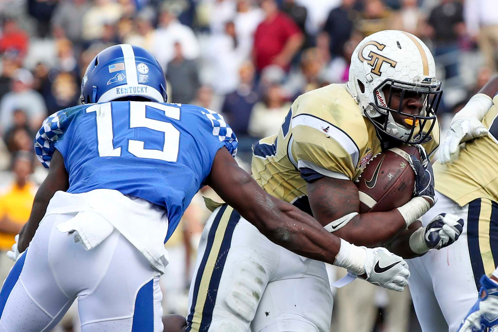 Georgia Tech Yellow Jackets running back Dedrick Mills (26) runs for a touchdown in the second half as Kentucky Wildcats safety Marcus McWilson (15) defends at EverBank Field. Logan Bowles-USA TODAY Sports