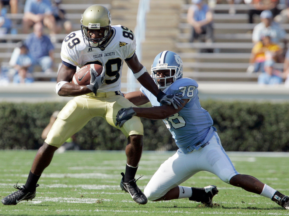 North Carolina's Jermaine Strong (38) tries to stop Georgia Tech's James Johnson (89) during the first half of a college football game in Chapel Hill, N.C., Saturday, Nov. 11, 2006. Georgia Tech won 7-0. (AP Photo/Gerry Broome)