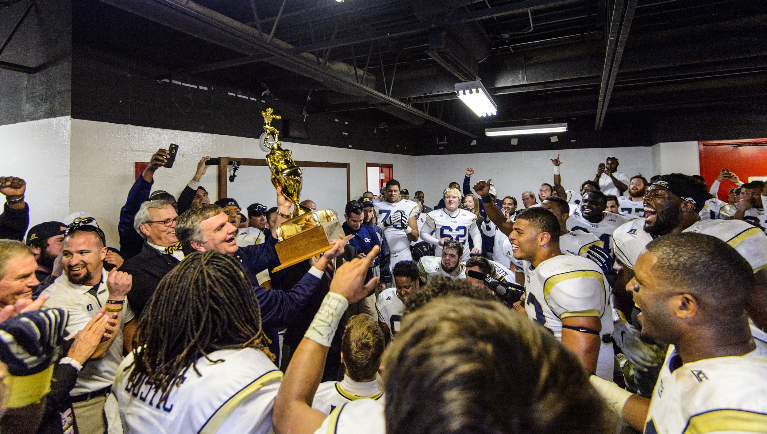 Coach Johnson and the team celebrate the big win over UGA in the locker room