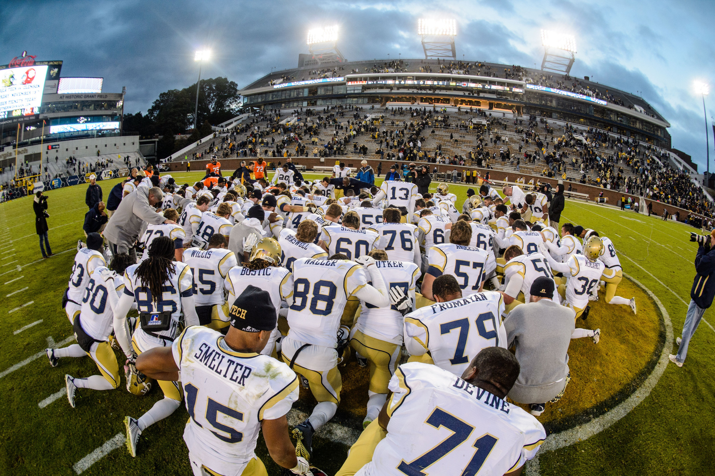 The team prays after the victory