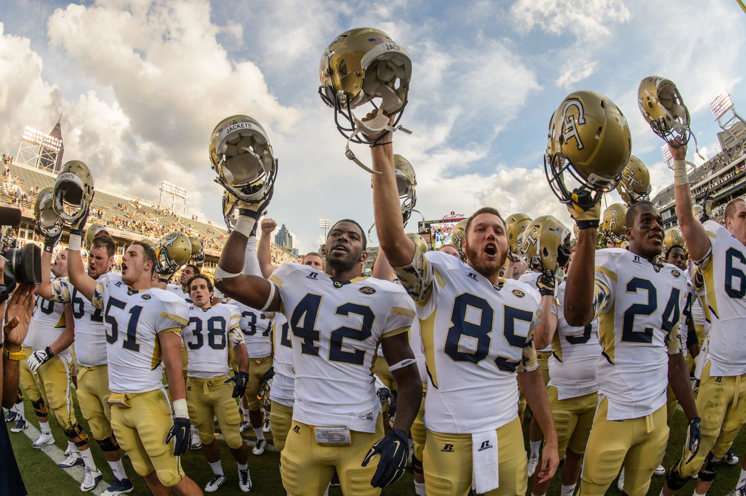 The Yellow Jackets sing the fight song with the fans after the win