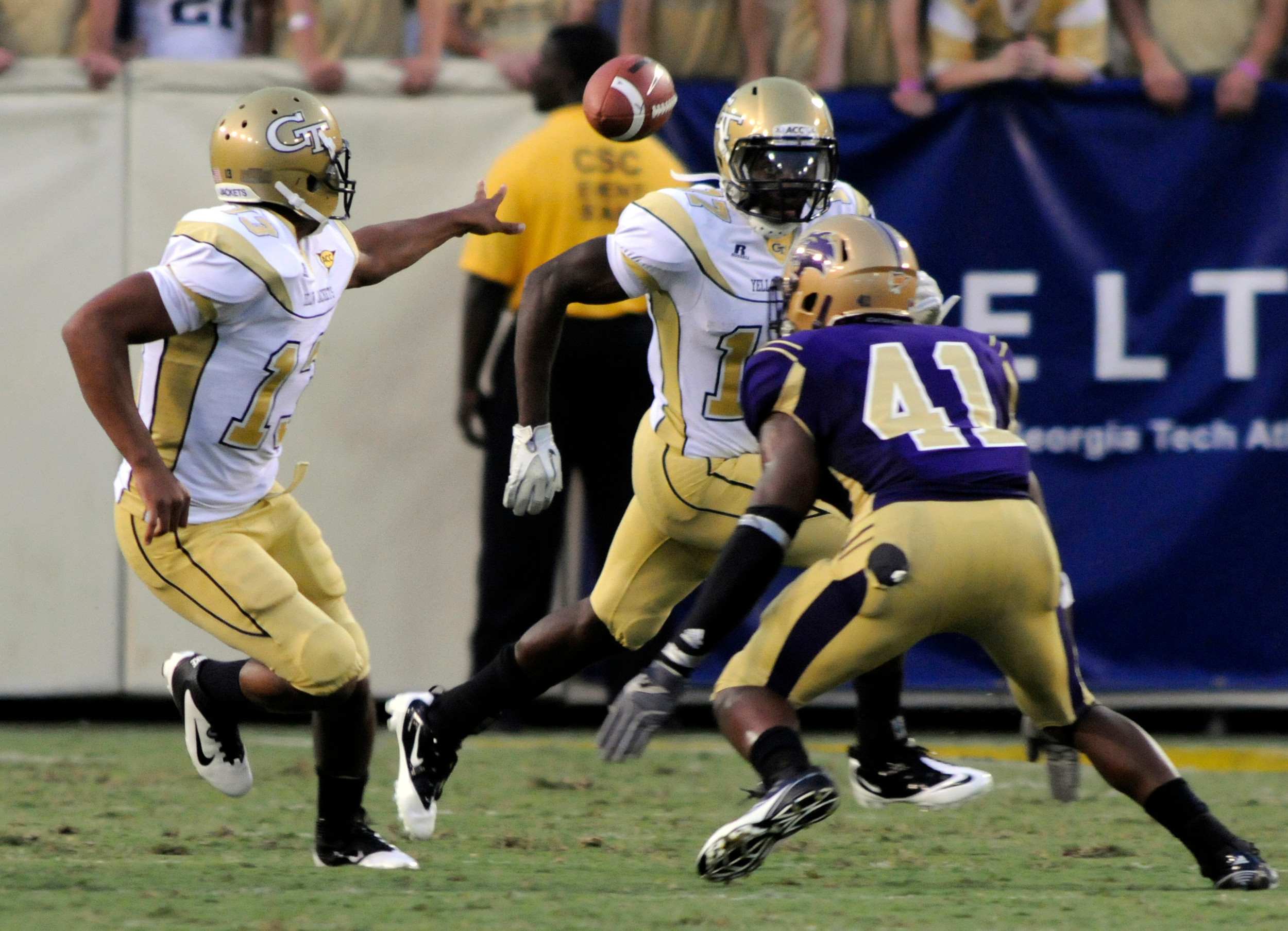 Georgia Tech quarterback Tevin Washington, left, pitches the ball to Orwin Smith as Western Carolina's Courtland Carson defends during an NCAA college football in Atlanta, Thursday, Sept. 1, 2011. AP Photo/Billy Weeks)