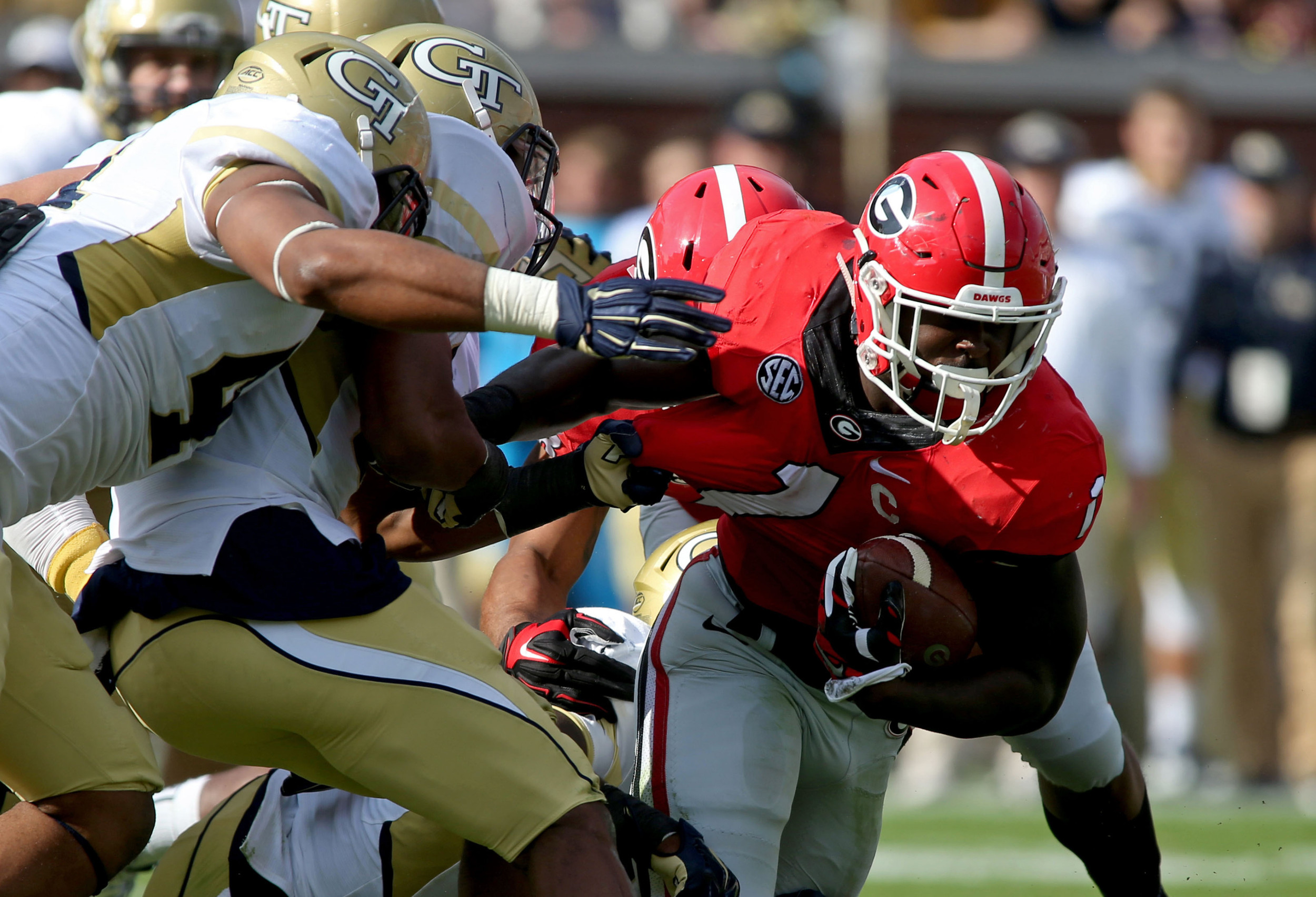 Georgia Bulldogs running back Sony Michel (1) runs against Georgia Tech Yellow Jackets defenders in the second quarter of their game at Bobby Dodd Stadium. Jason Getz-USA TODAY Sports