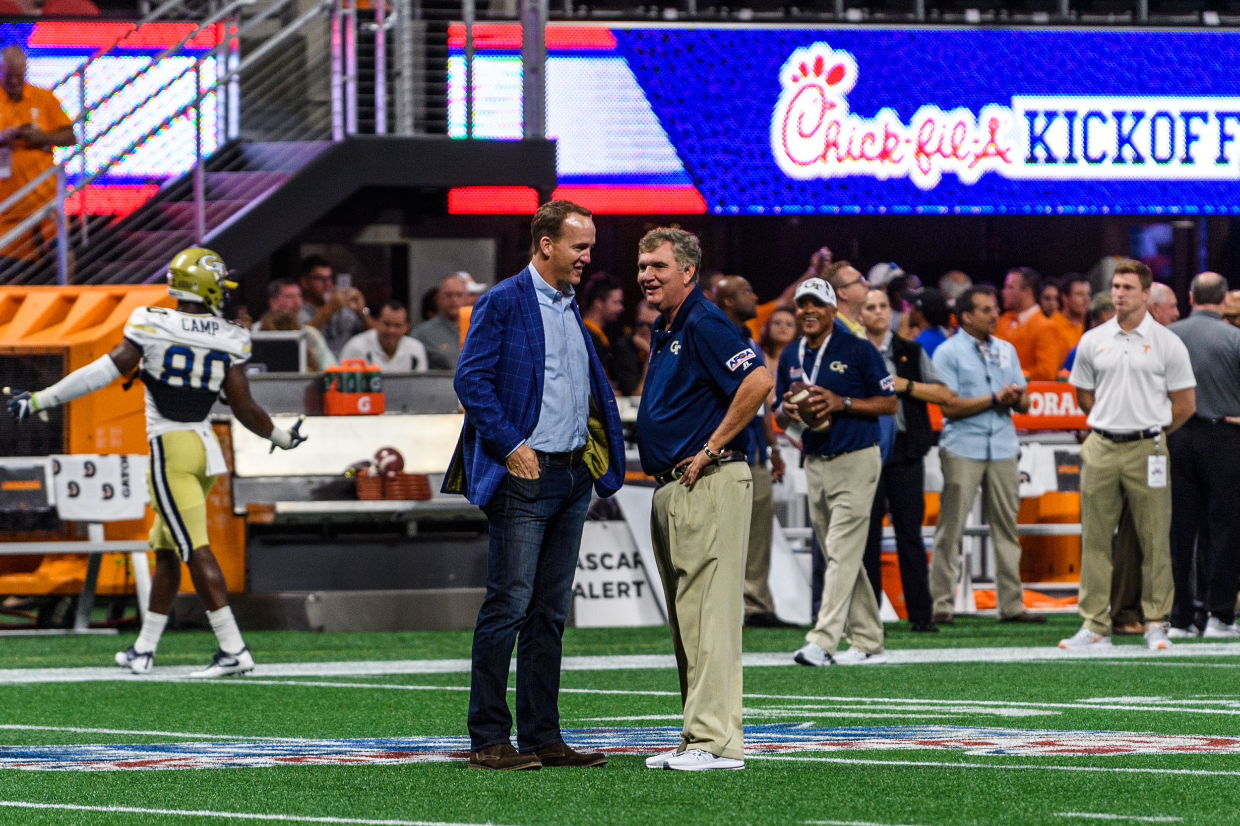 Coach Paul Johnson talks with Peyton Manning before the game