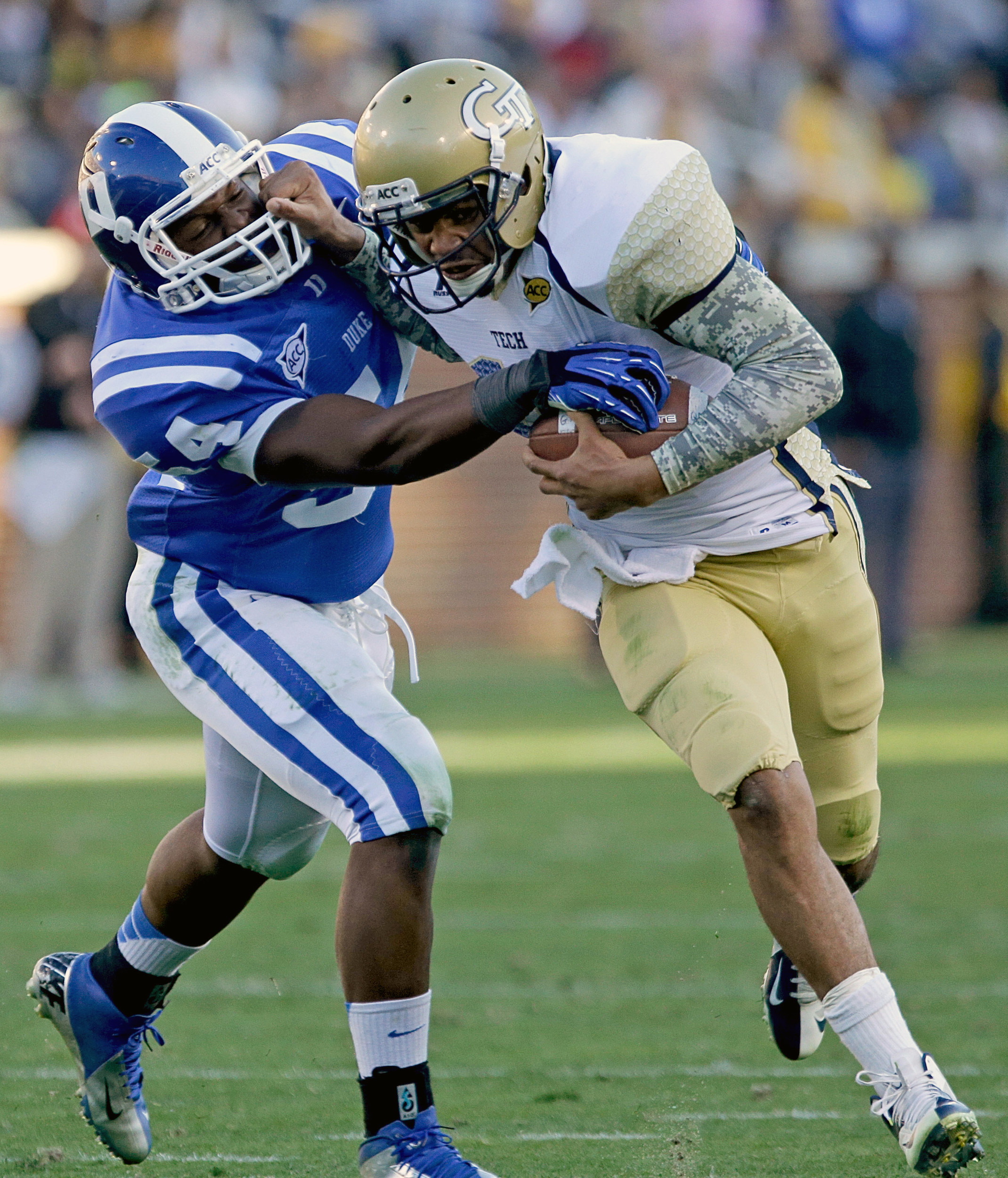 Georgia Tech quarterback Tevin Washington, right, runs the ball against the defense of Duke's C.J. France in the first quarter. (AP Photo/David Goldman)