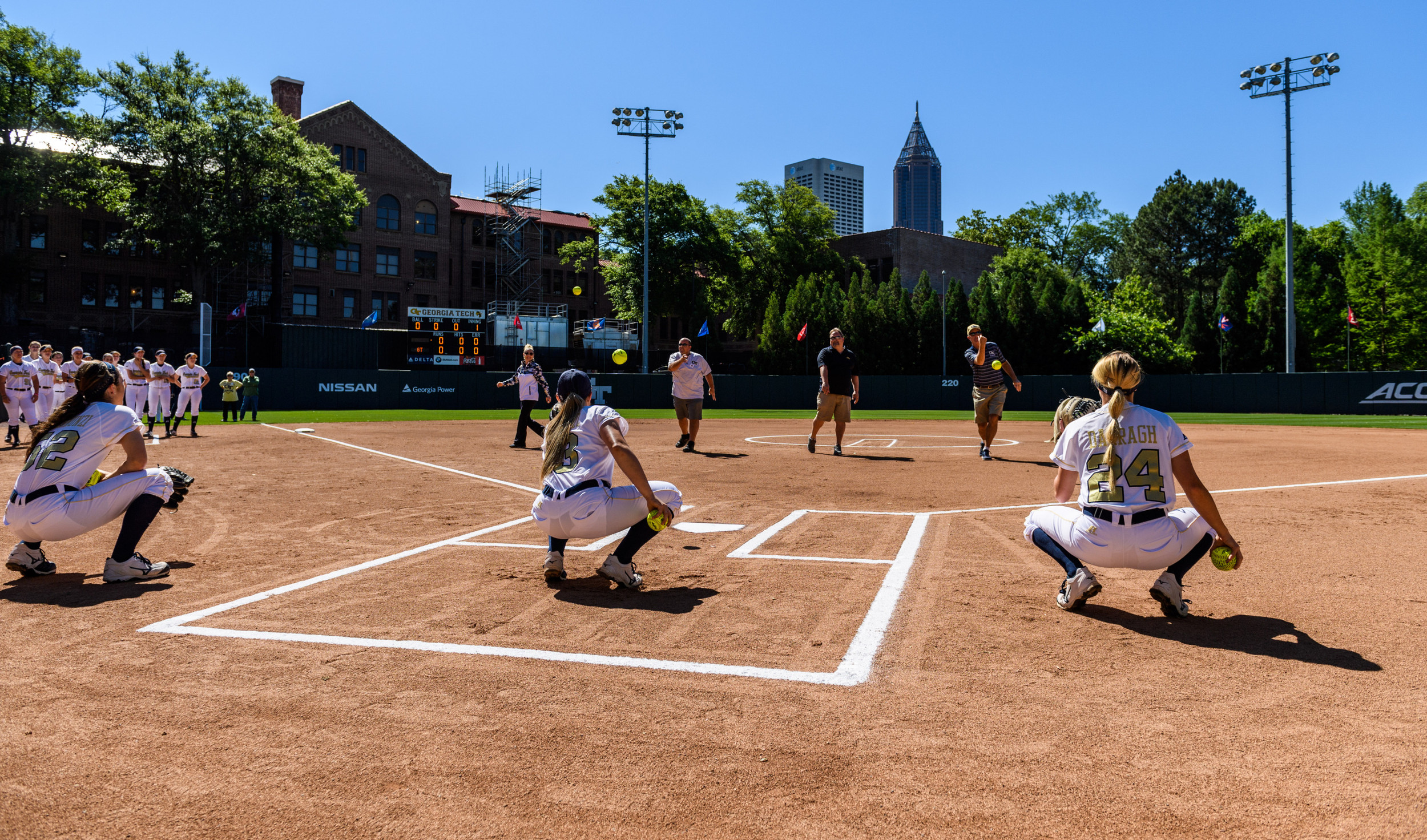 The senior dads throw out first pitches to their daughters