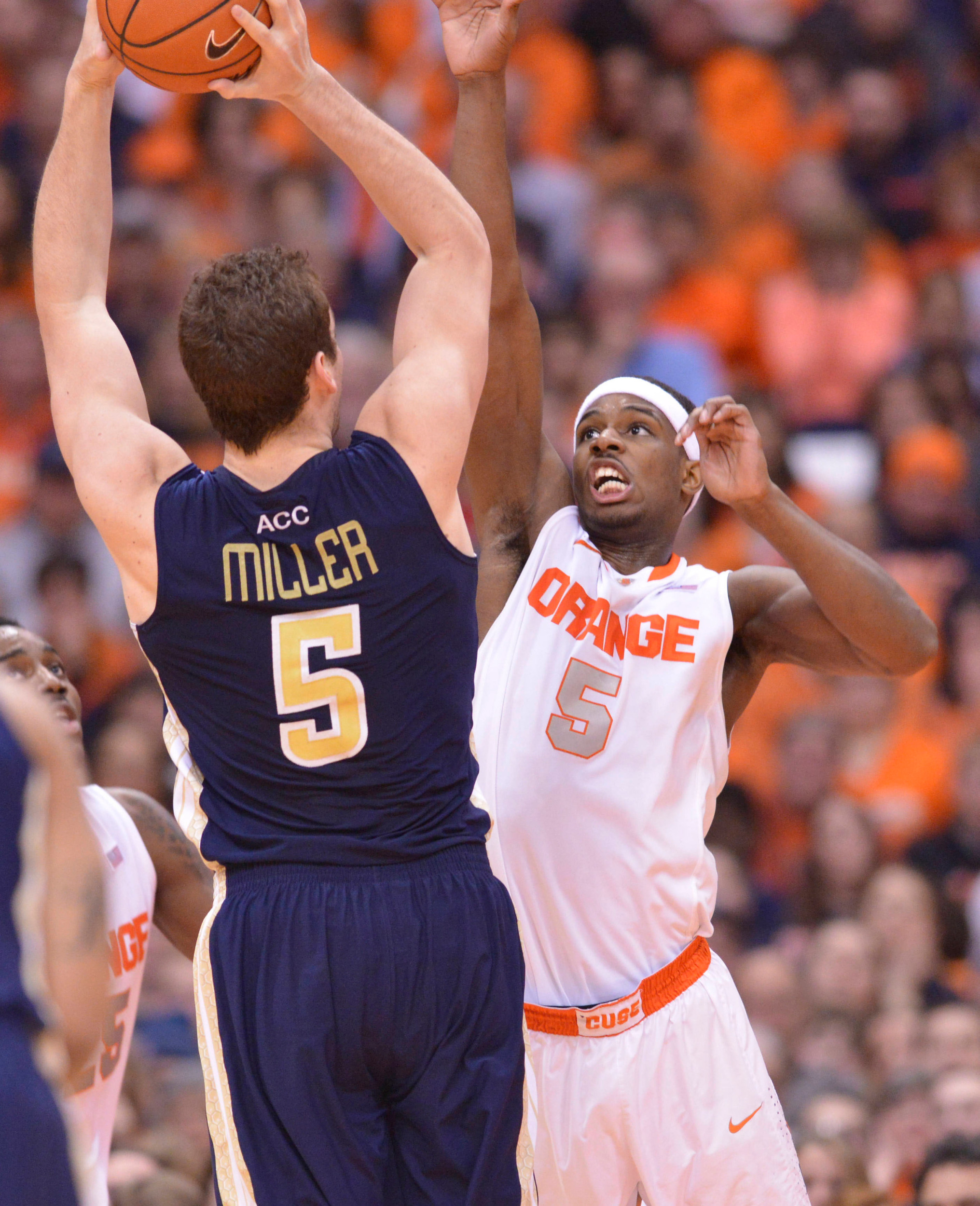 Mar 4, 2014; Syracuse, NY, USA; Syracuse Orange forward C.J. Fair (right) looks to block a shot of Georgia Tech Yellow Jackets center Daniel Miller (5) during the second half of a game at the Carrier Dome. Georgia Tech won the game 67-62. Mandatory Credit: Mark Konezny-USA TODAY Sports