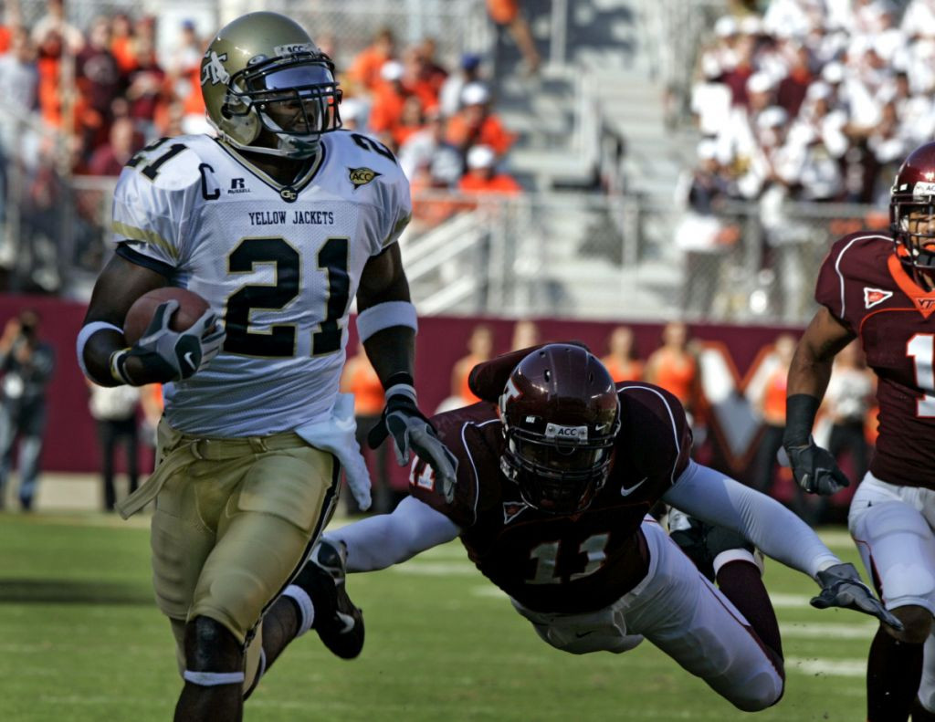 Georgia Tech wide receiver Calvin Johnson (21) runs is for a touchdown as Virginia Tech defender Xavier Adibi (11) makes a last attempt for a tackle during first half action of the Georgia Tech-Va Tech Atlantic Coast Conference college football game at Lane stadium in Blacksburg, Va., Saturday Sept. 30, 2006. (AP Photo/Steve Helber)