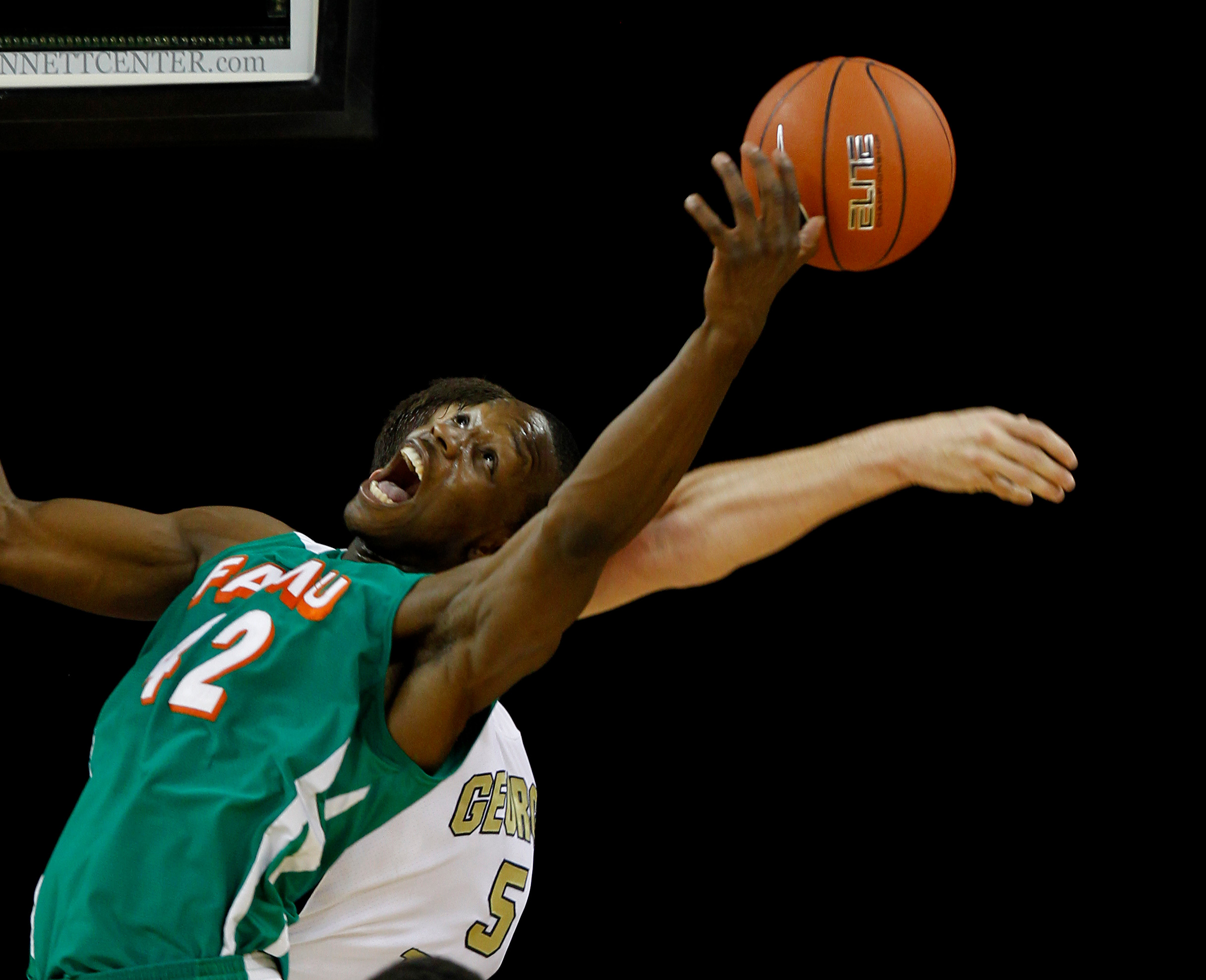 CORRECTS TO FLORIDA A&M'S YANNICK CROWDER (42) NOT REGGIE LEWIS (12) - Florida A&M's Yannick Crowder (42) and Georgia Tech center Daniel Miller (5) fight for a rebound in the first half of an NCAA college basketball game in Duluth, Ga., Friday, Nov. 11, 2011. (AP Photo/John Bazemore)