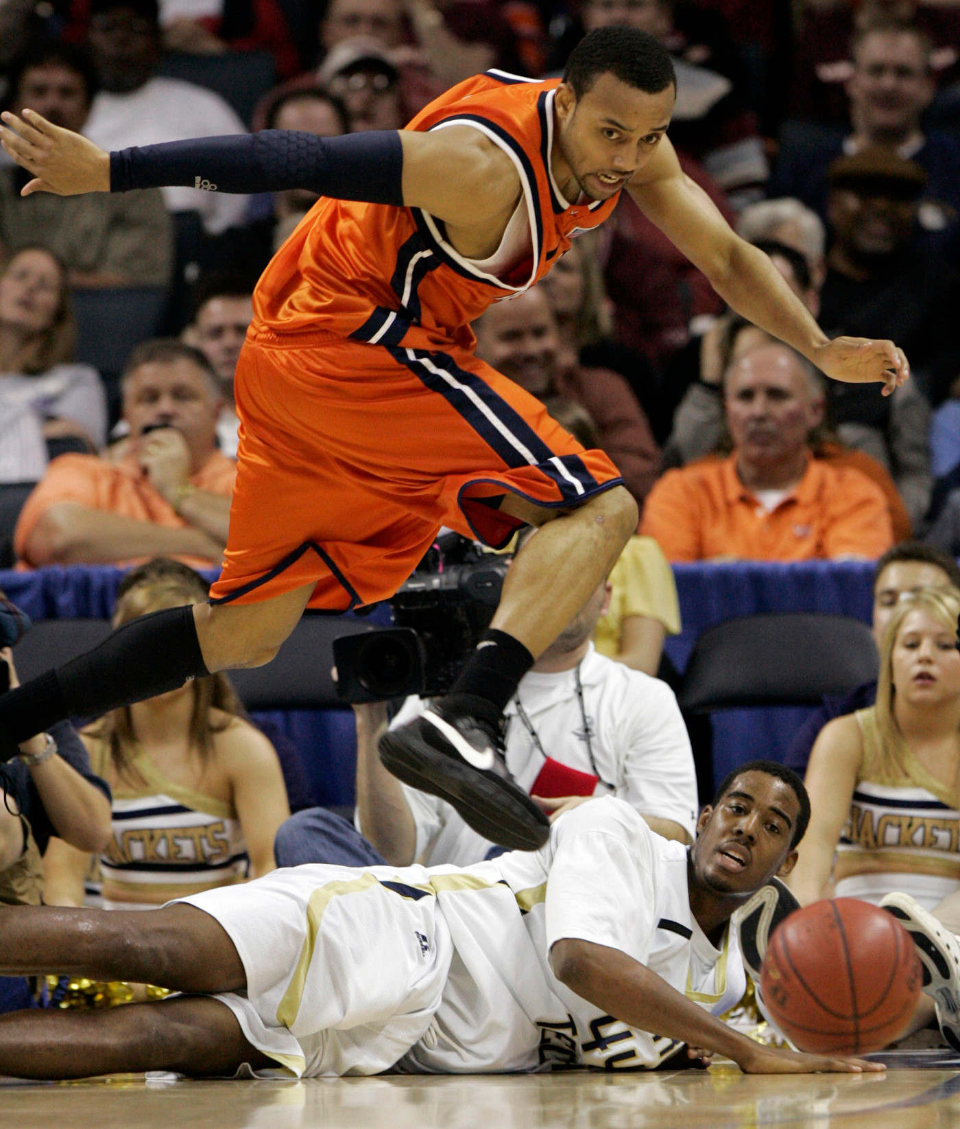 Virginia's Calvin Baker, top, and Georgia Tech's Alade Aminu chase a loose ball in the second half of an Atlantic Coast Conference basketball tournament game at Bobcats Arena in Charlotte, N.C., Thursday, March 13, 2008. Georgia Tech won, 94-76. (AP Photo/Steve Helber)