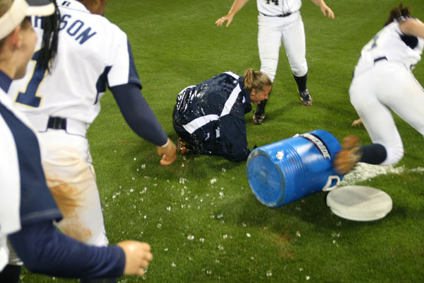 The team gives head coach Sharon Perkins an ice bath