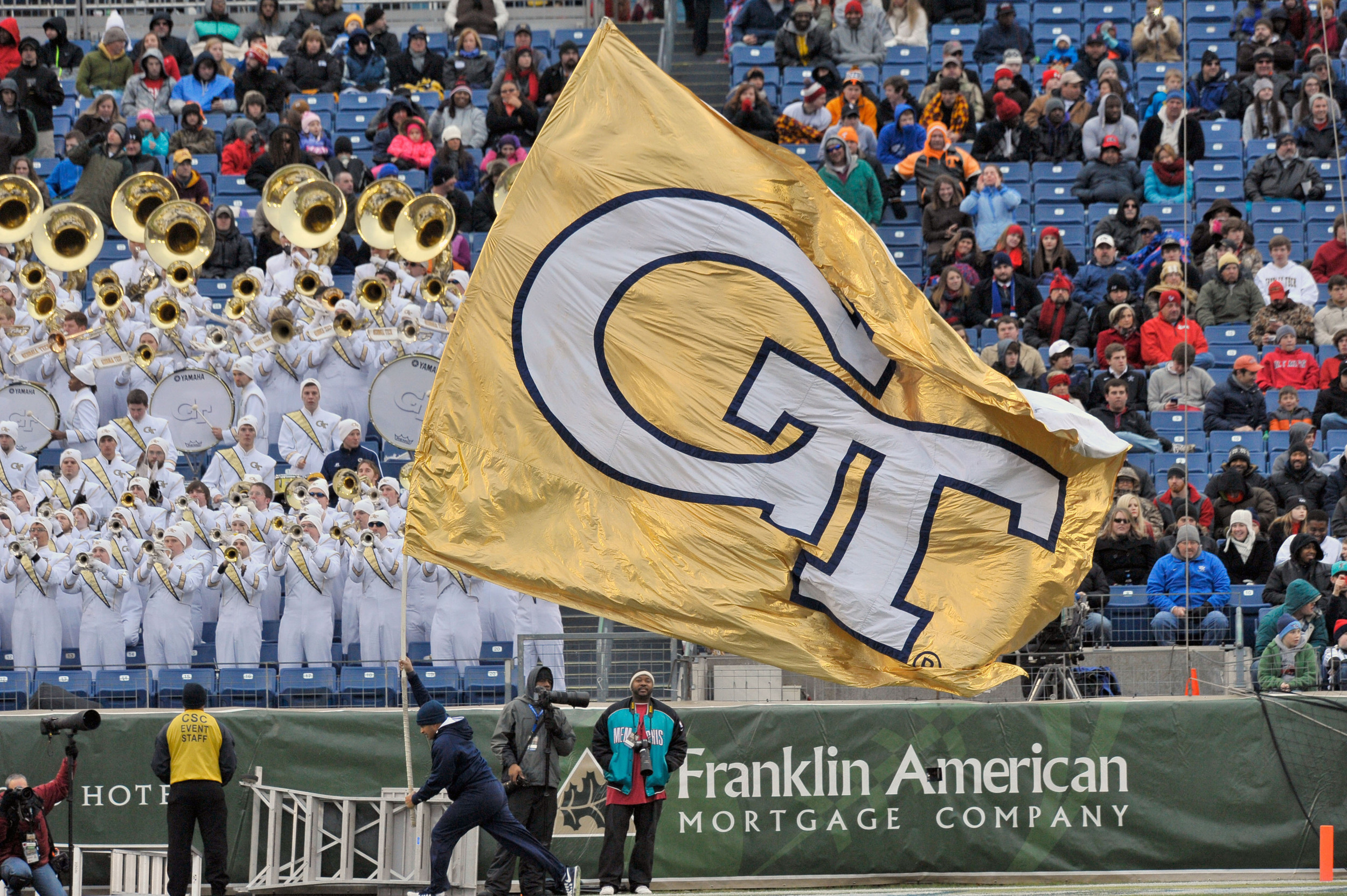 Georgia Tech Yellow Jackets flag bearer celebrates Georgia Tech Yellow Jackets running back Robert Godhigh (25) scoring a touchdown against the Mississippi Rebels. Mandatory Credit: Jim Brown-USA TODAY Sports