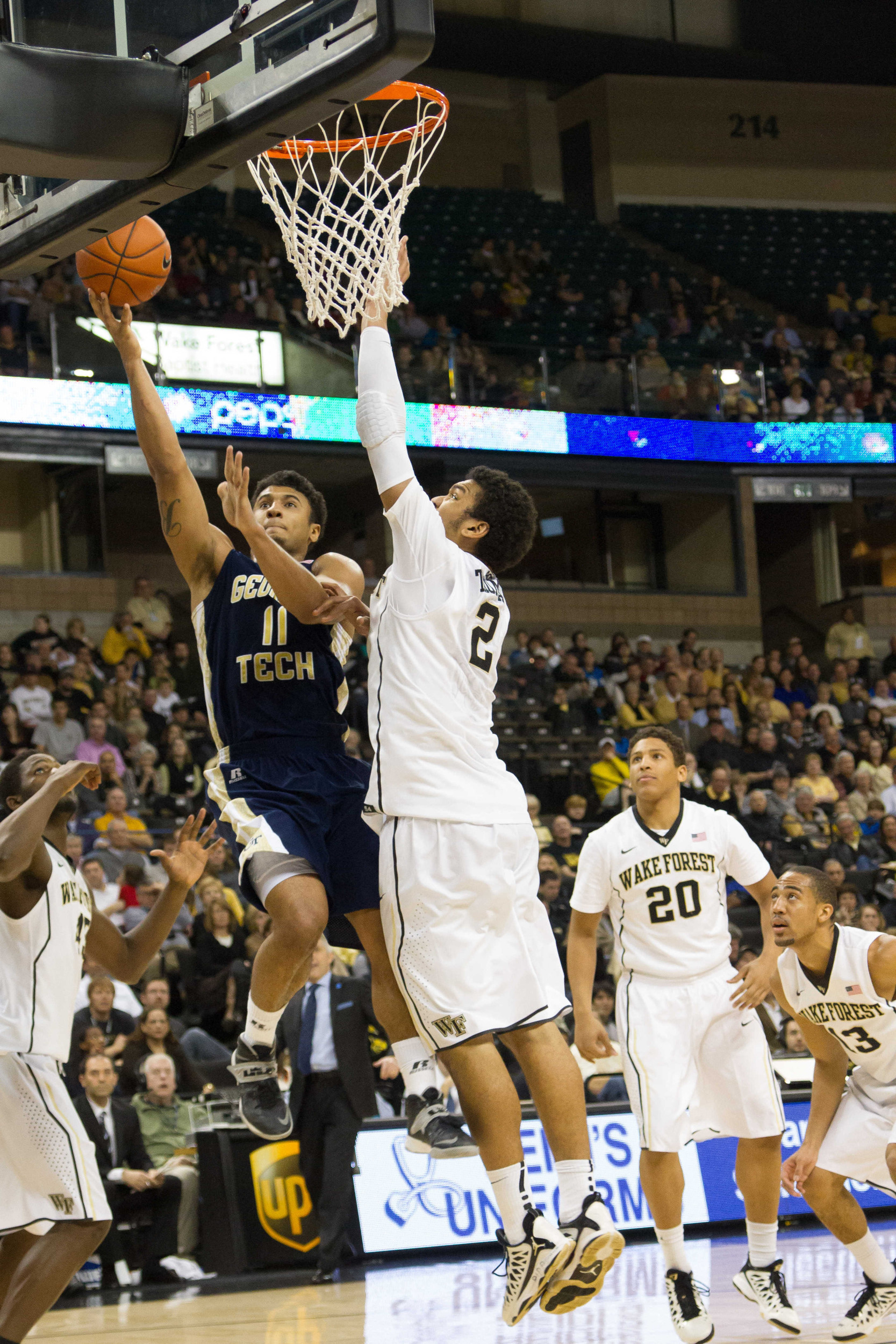 Feb 1, 2014; Winston-Salem, NC, USA; Yellow Jackets guard Chris Bolden (11) goes up for a shot against Wake Forest Demon Deacons forward Devin Thomas (2) during the second half. Jeremy Brevard-USA TODAY Sports